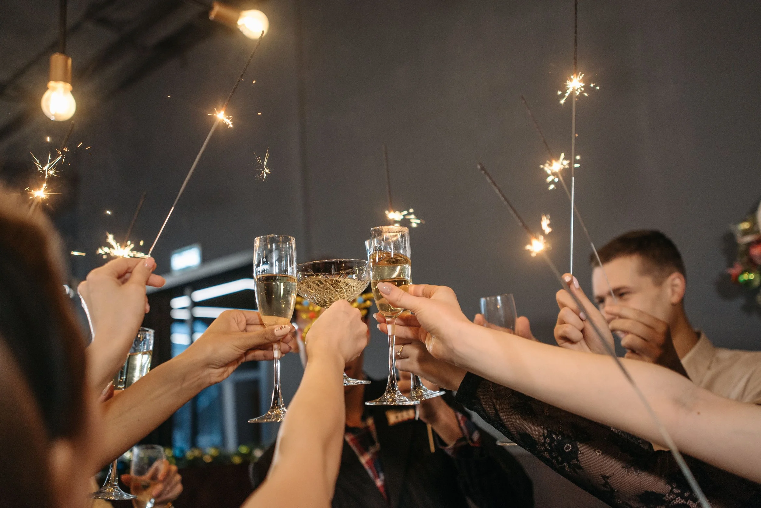 Guests raising glasses with sparklers at a celebration