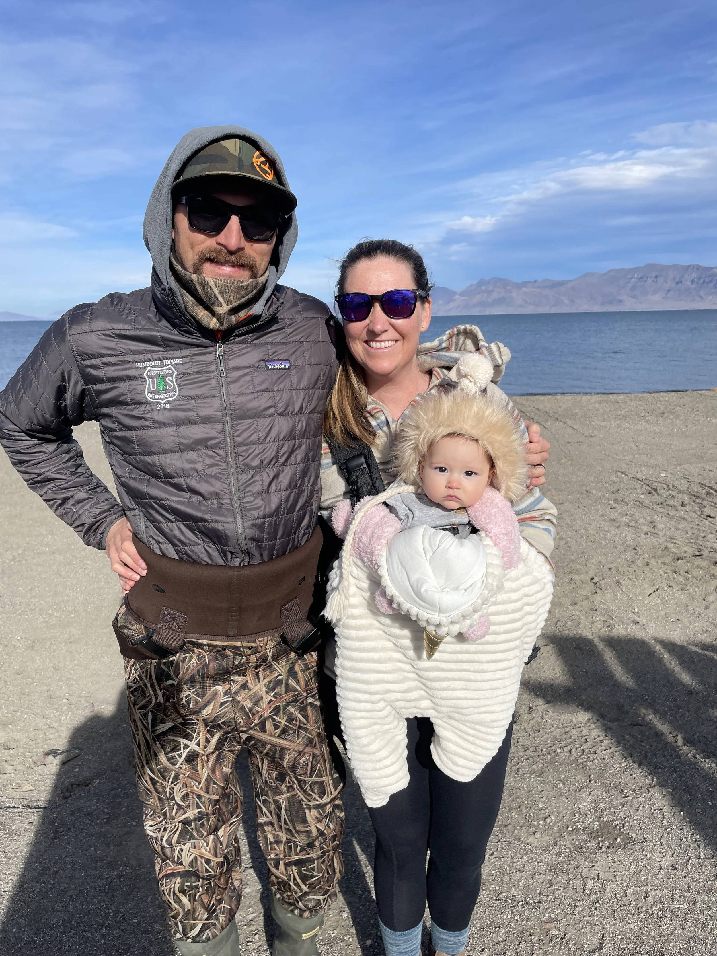 Owners Cooper and Moriah with their daughter by a lake