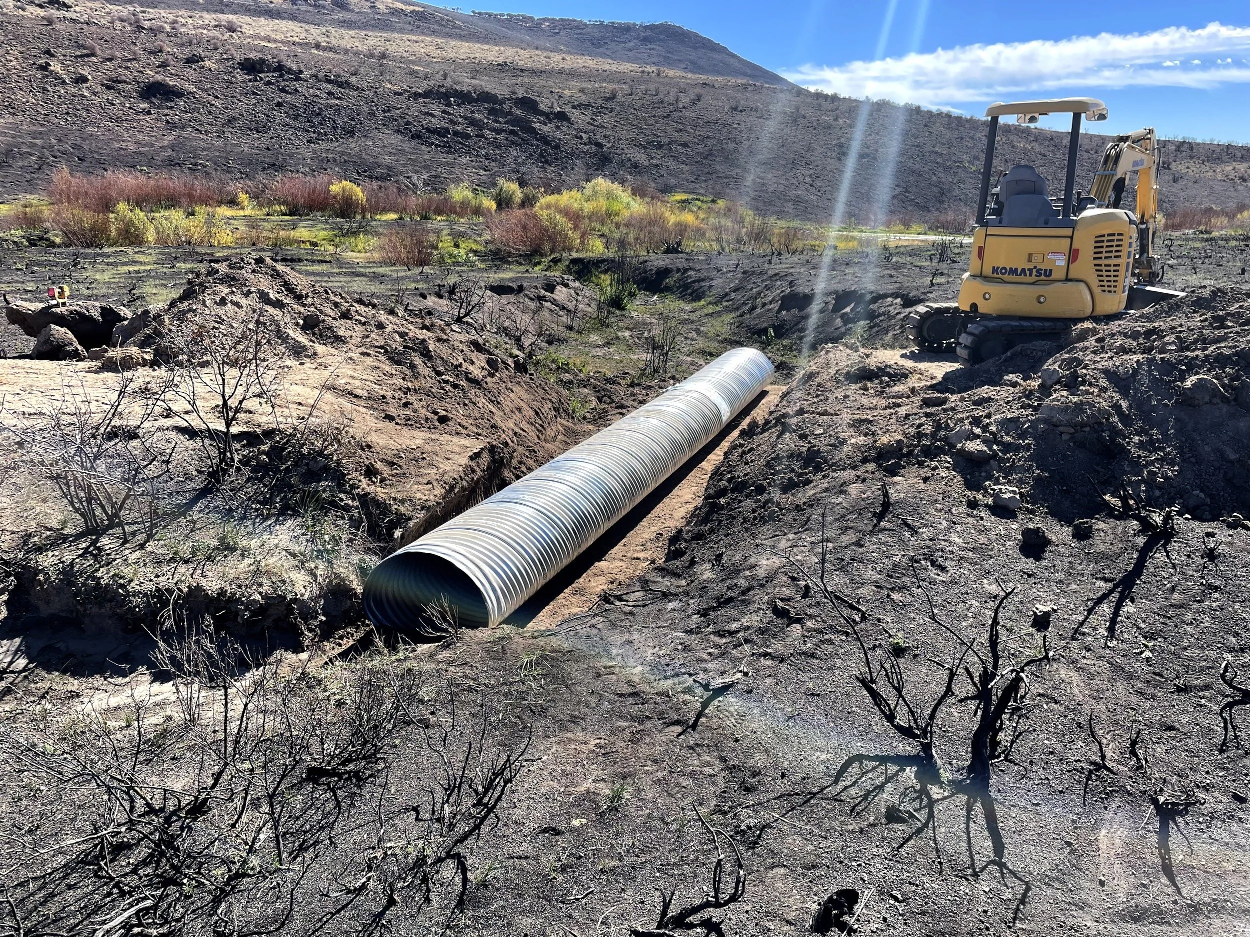 Corrugated culvert pipe on cleared ground