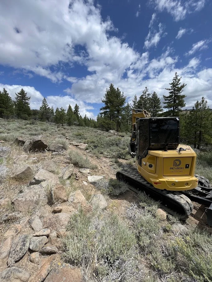 Excavator building a multi-use trail in Northern Nevada terrain
