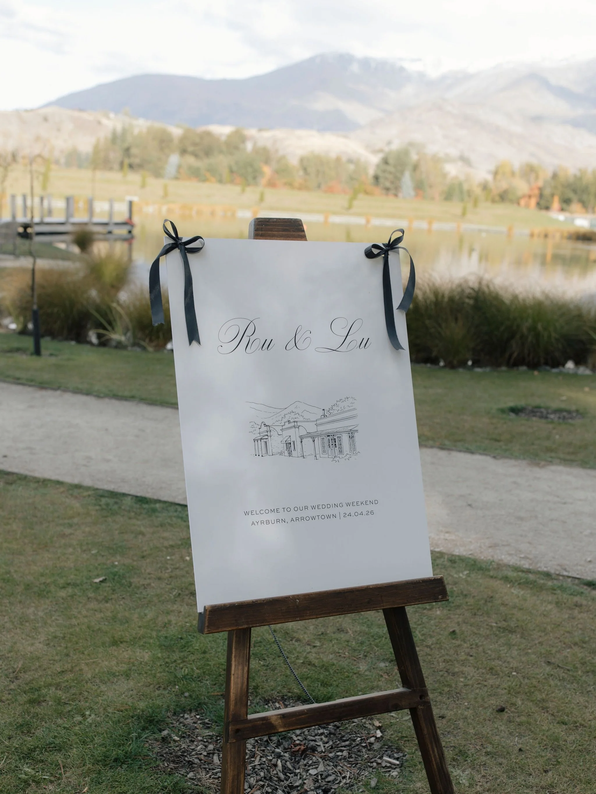 At Ayrburn in Arrowtown, Lucy &amp; Rupert&rsquo;s day unfolded on a perfect mid-Autumn day. For their signage and collateral, we created a bespoke Arrowtown illustration that was woven through every piece of their signage and stationery. Set against