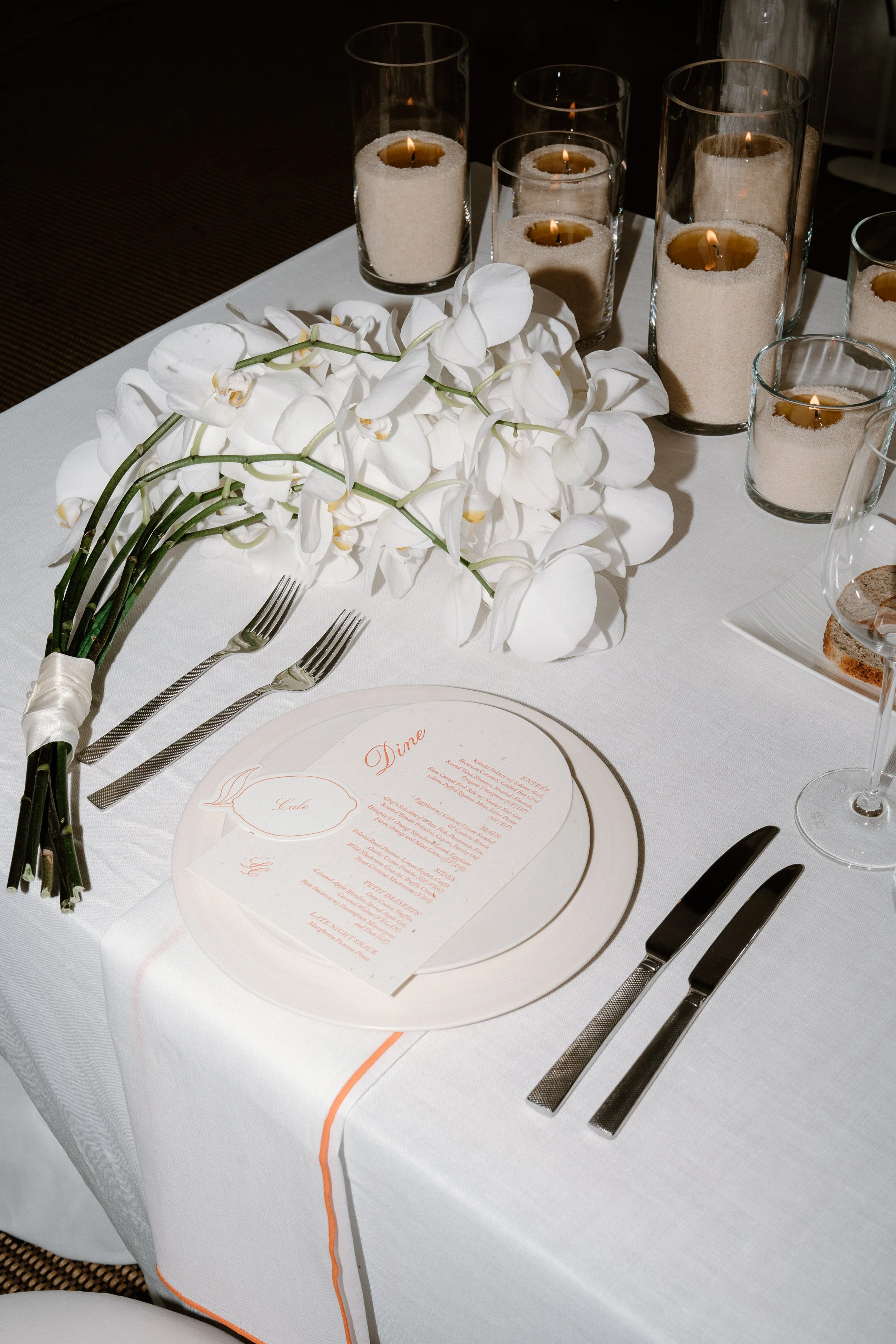Wedding stationery nz - place setting with menu card and candles, Sam and Cale's wedding