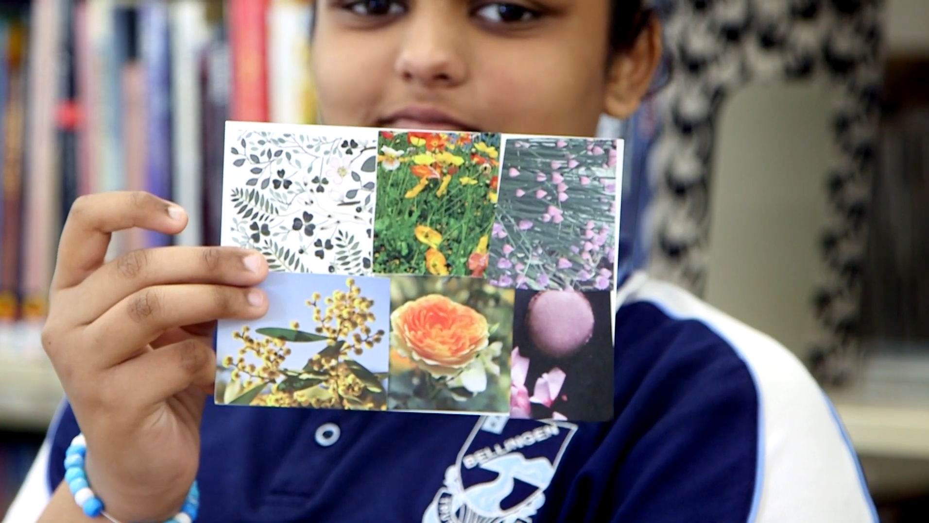 A high school participant holding her completed postcard and smiling