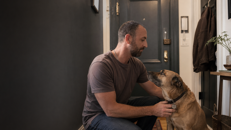 Pepe calming a distressed dog at home during separation anxiety training in NYC