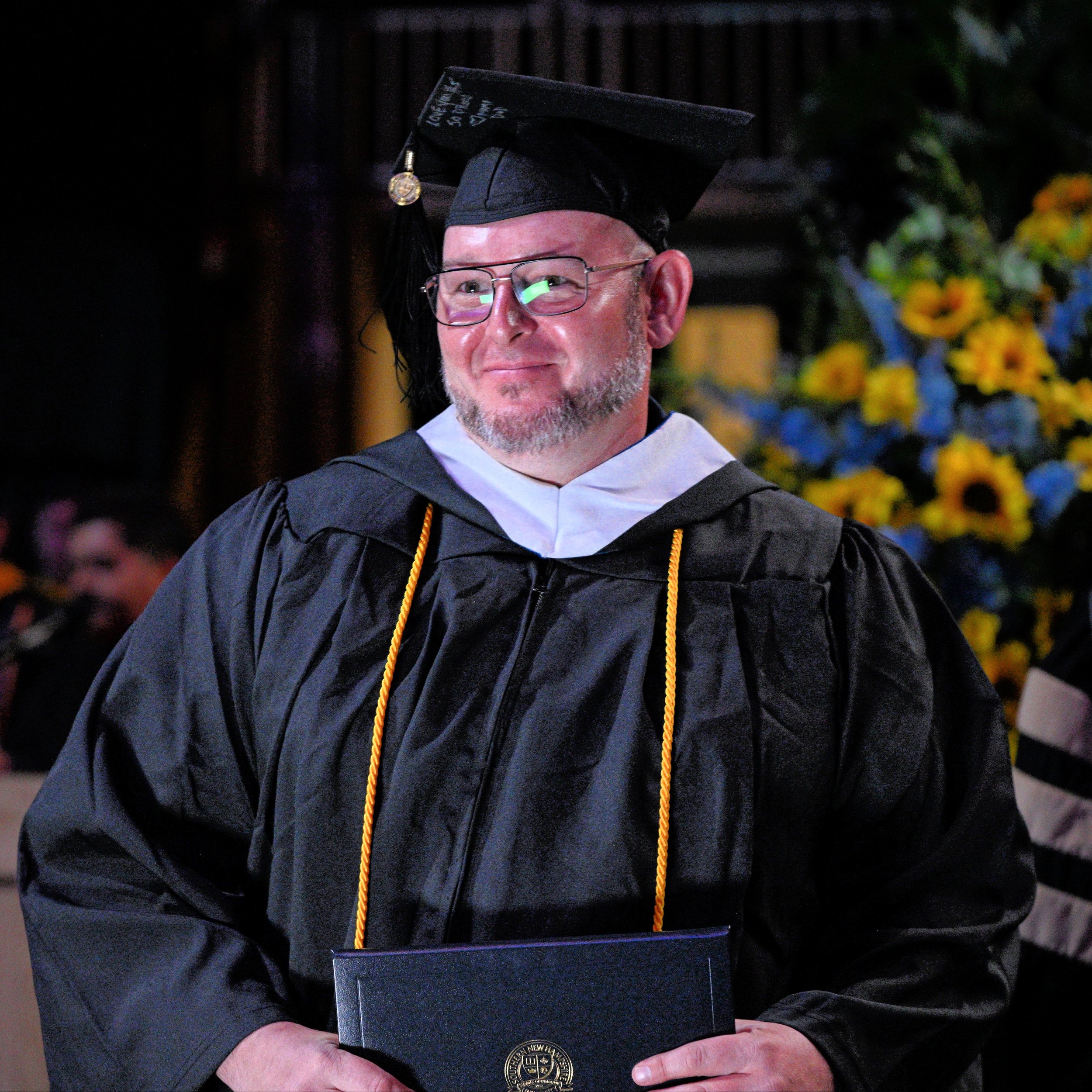 picture of man in graduation cap and gown