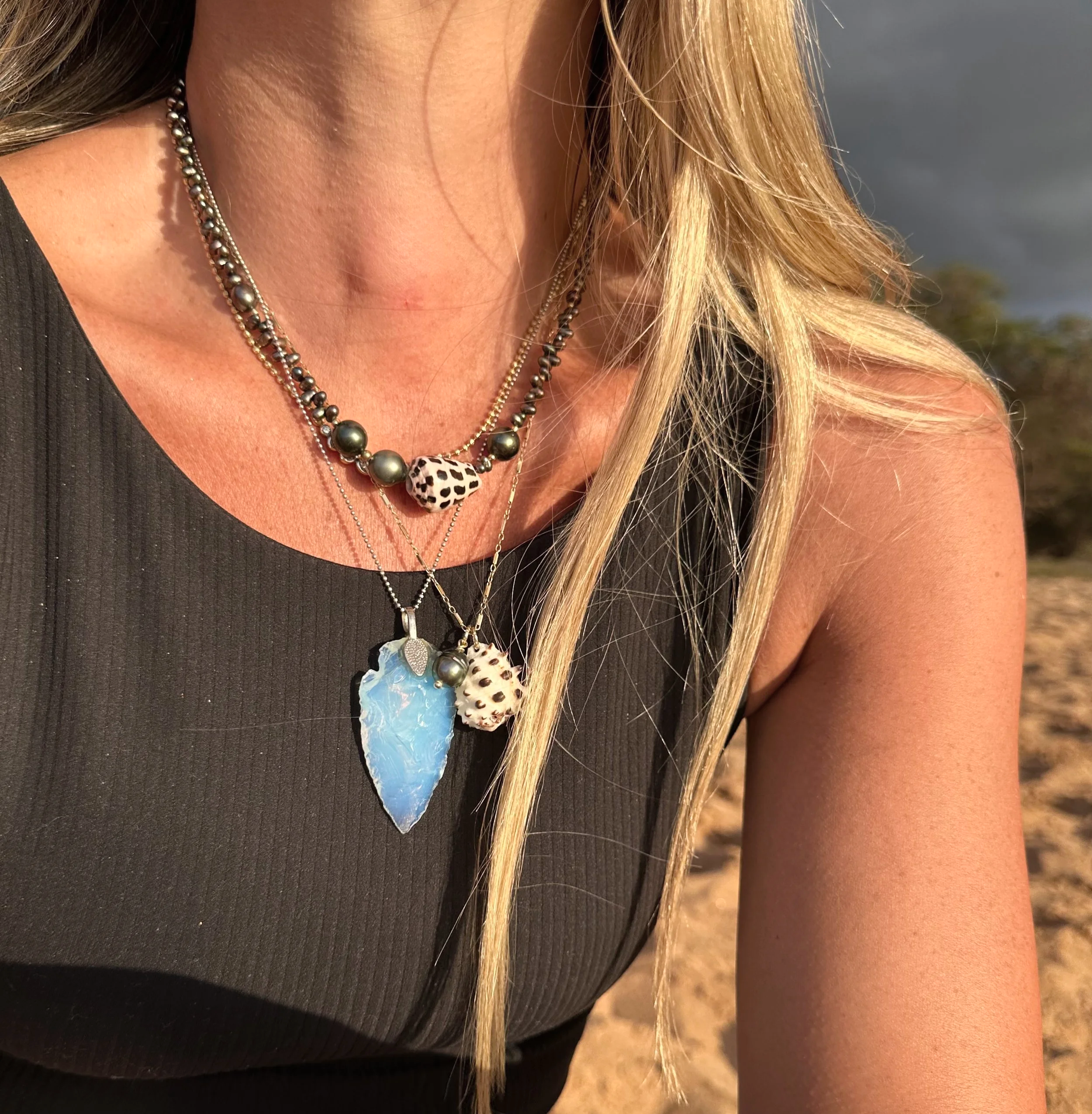peacock and tahitian pearl choker with hebrew cone shell. hawaiian drupe shell pendant on chain. opal glass arrowhead pendant necklace.