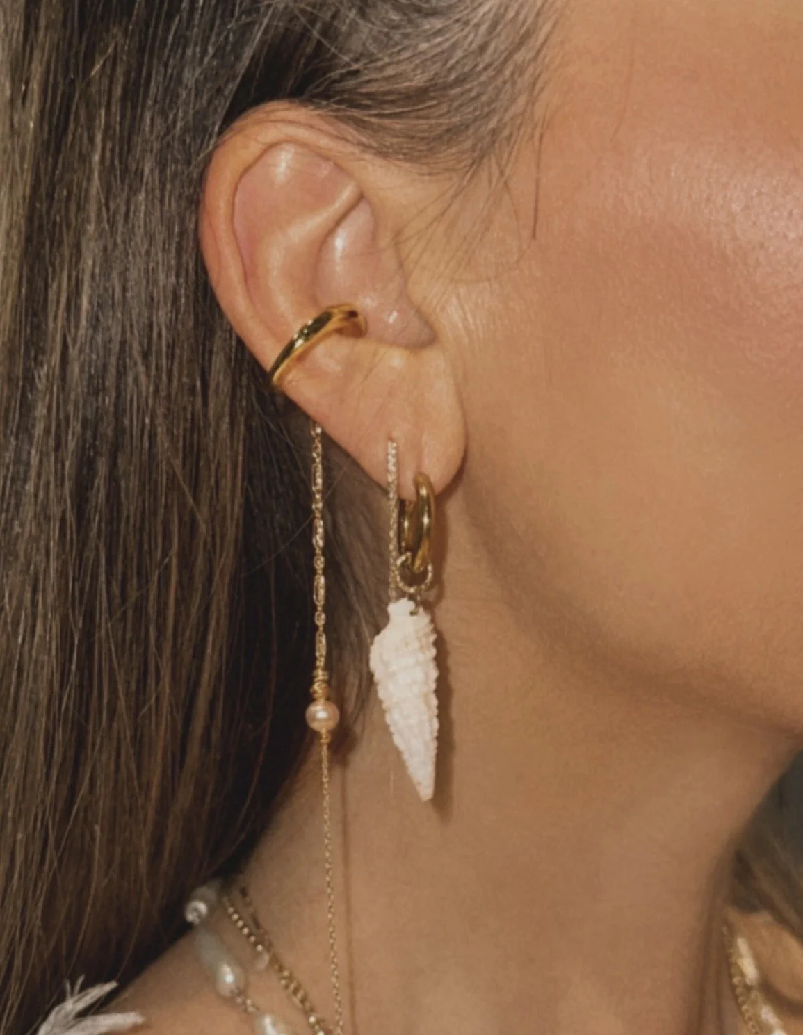 stackable mix and match earrings. cerith shell hoop earring, pink fresh water pearl ear cuff with accent dangle chain.