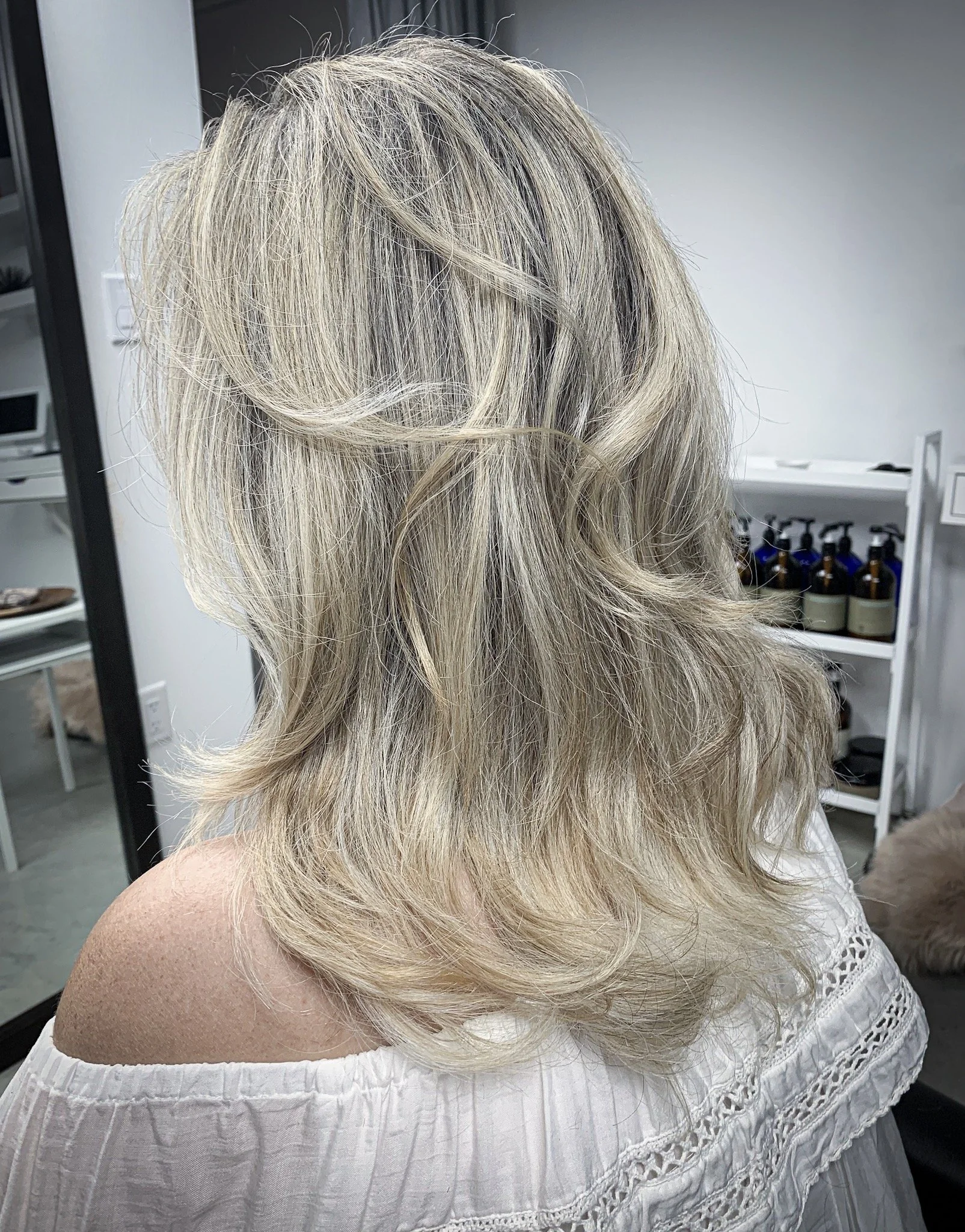 Woman with blonde layered hairstyle in a salon