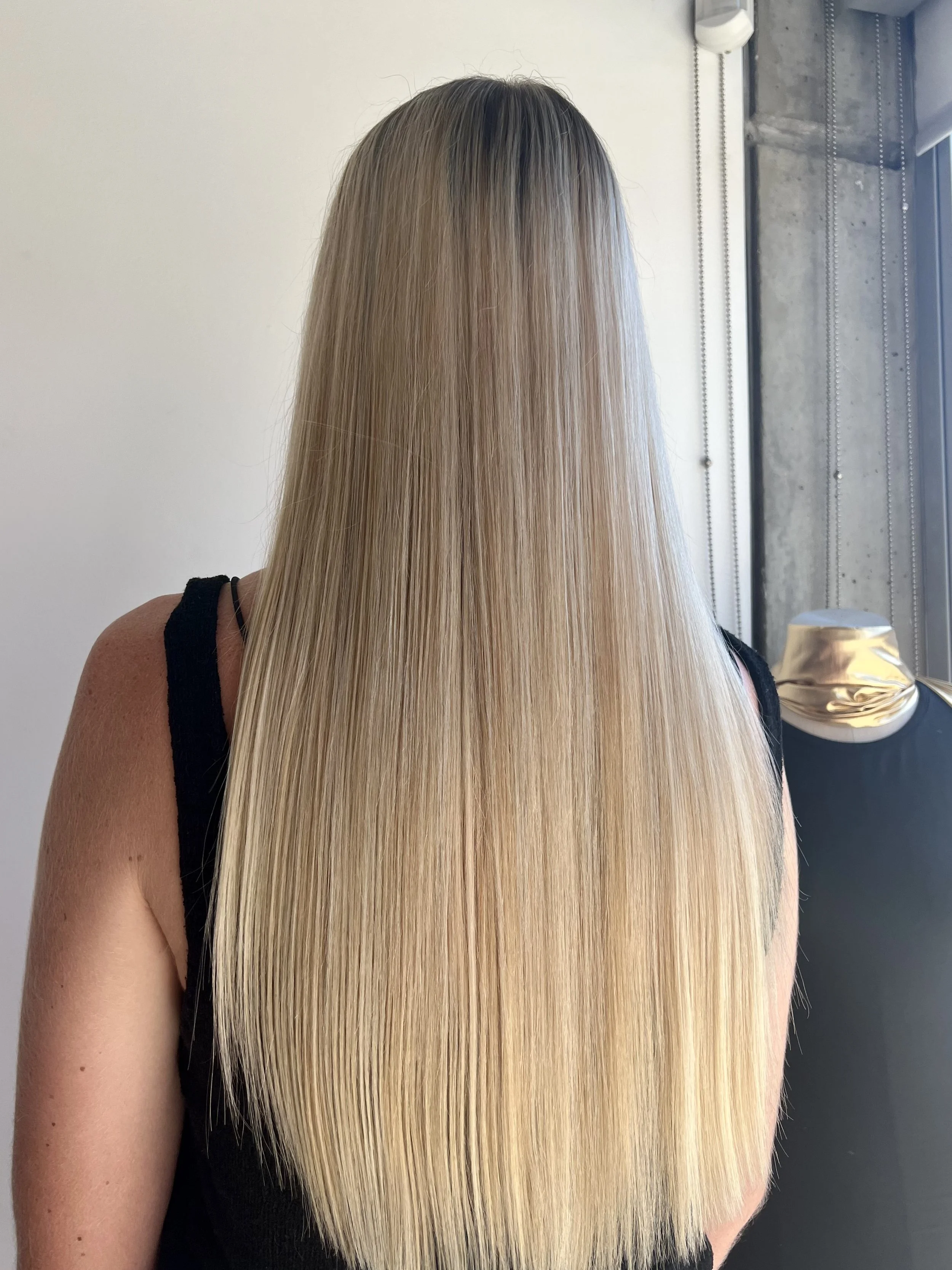Long straight blonde hair from the back