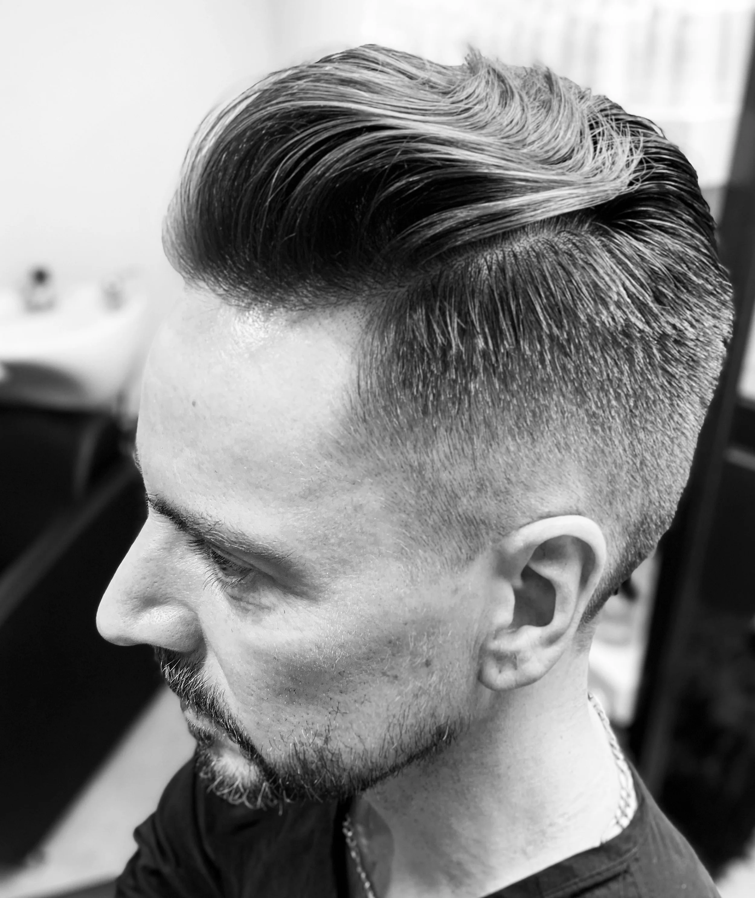 Side view of a man with styled hair and trimmed beard