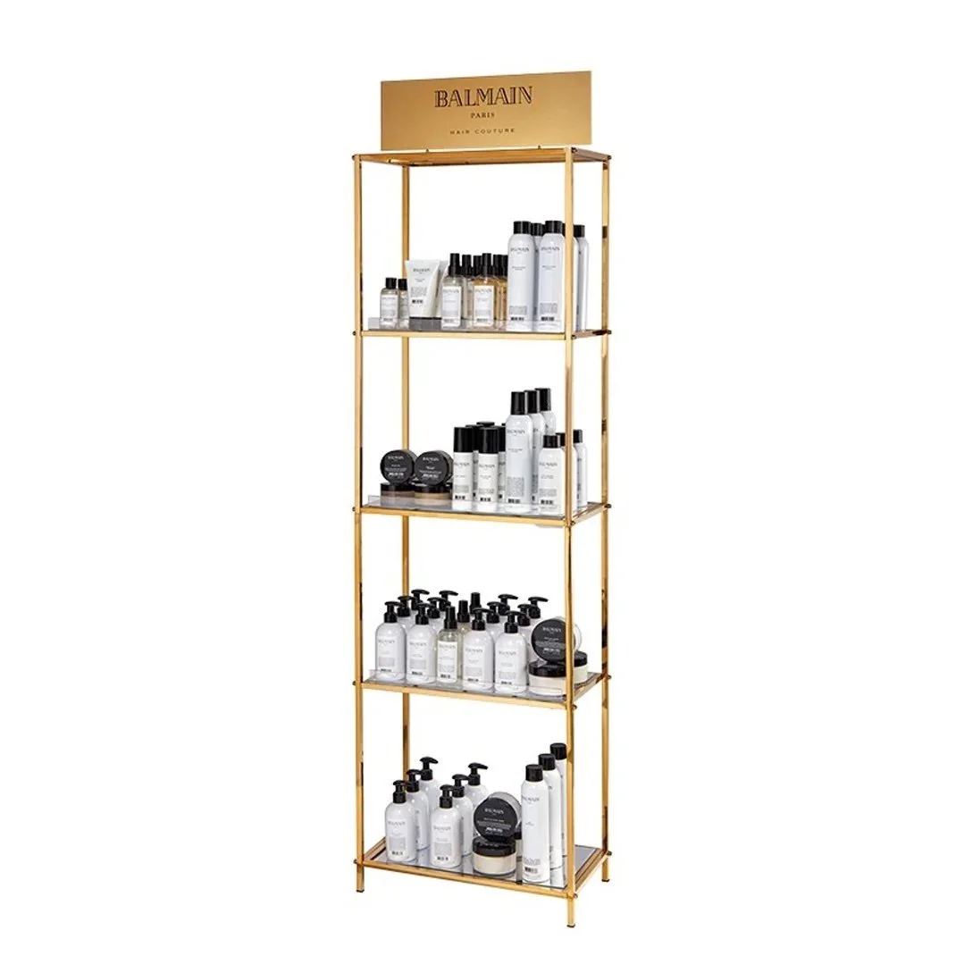 Display rack with Balmain Paris hair products, including bottles and jars, organized on shelves.
