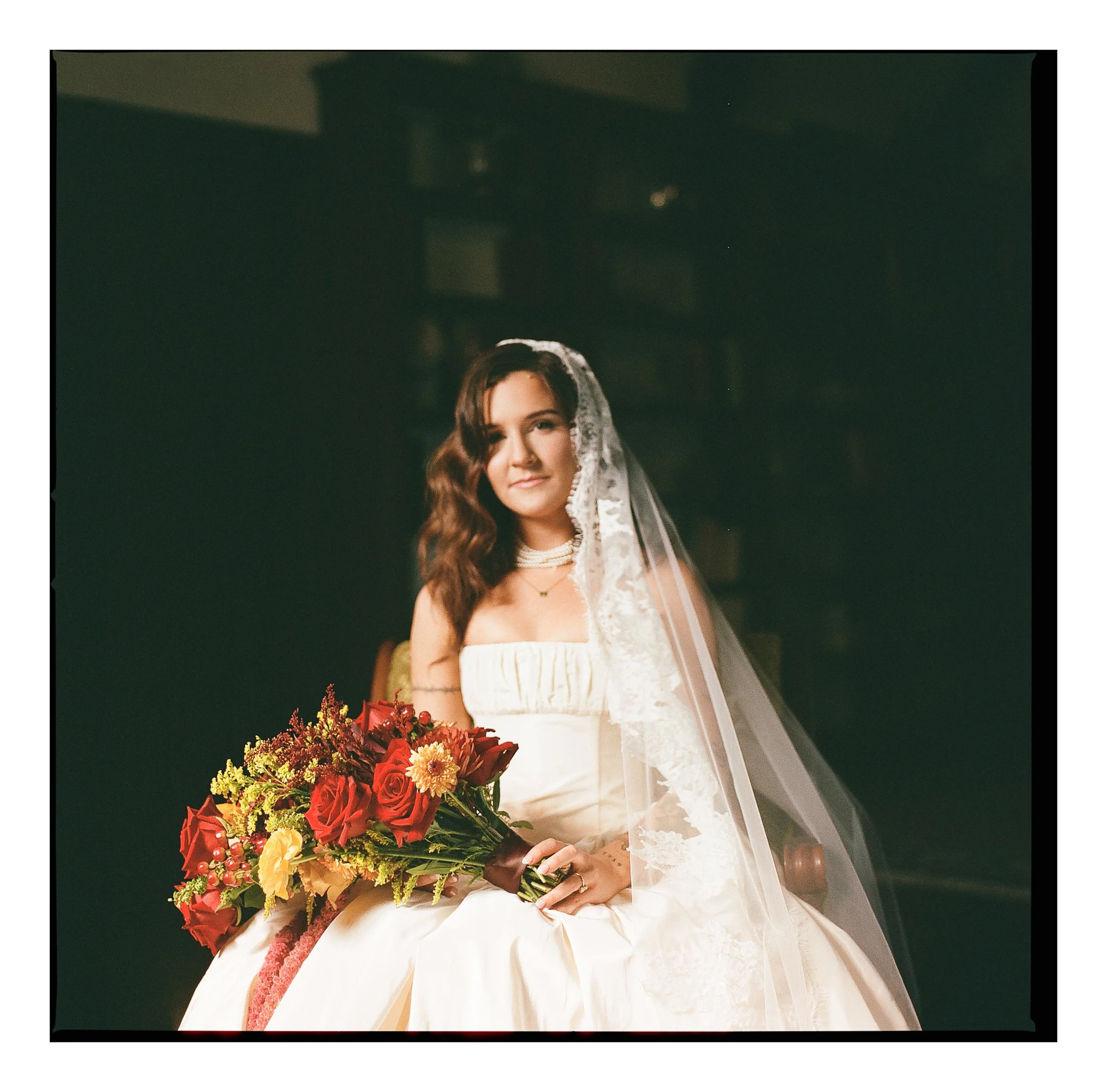 A bride poses for an analog film photo at a historic hotel in Northern Spain, getting ready for her elopement in Picos de Europa.