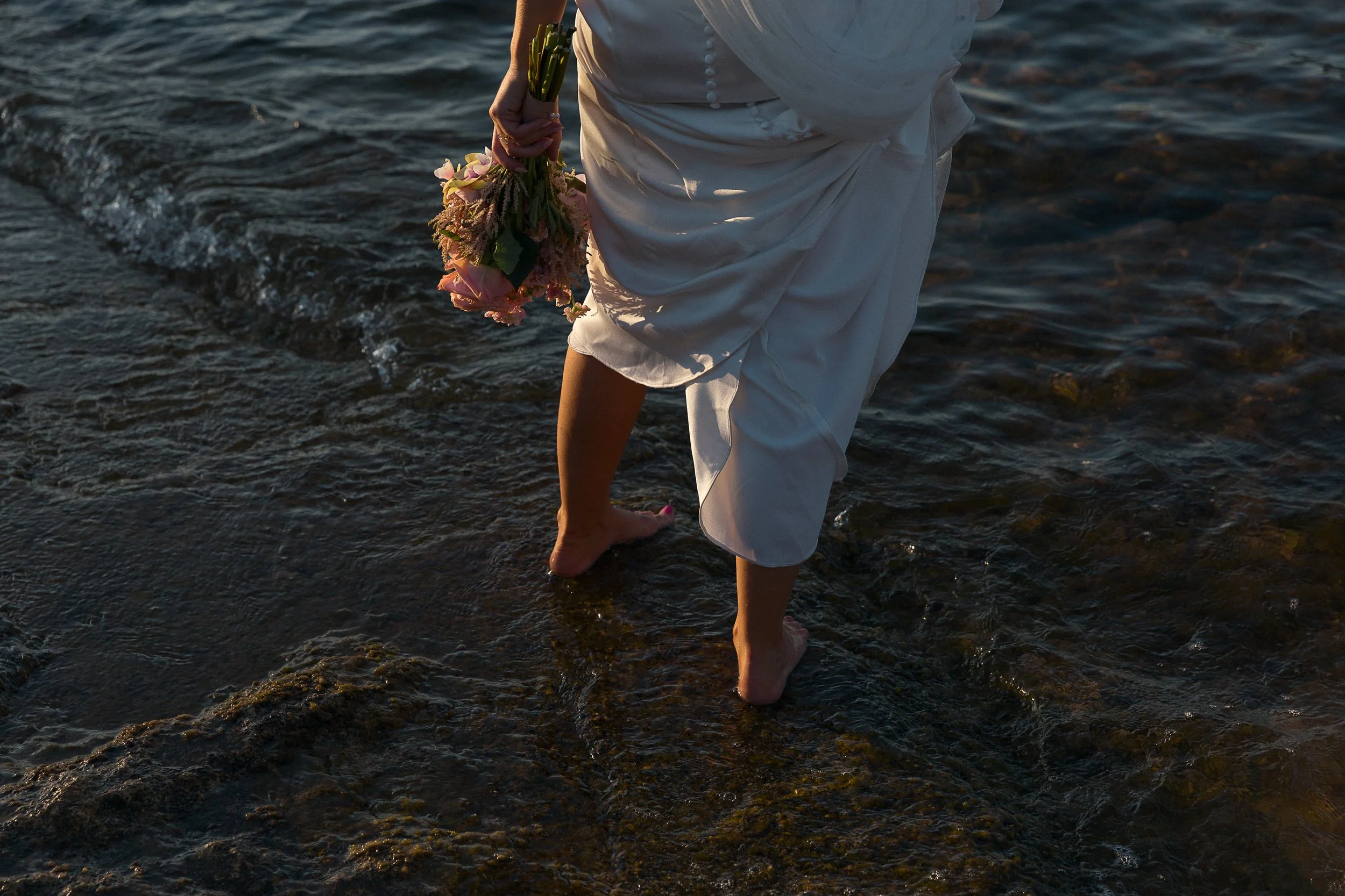 A bride standing in the sea in Mallorca