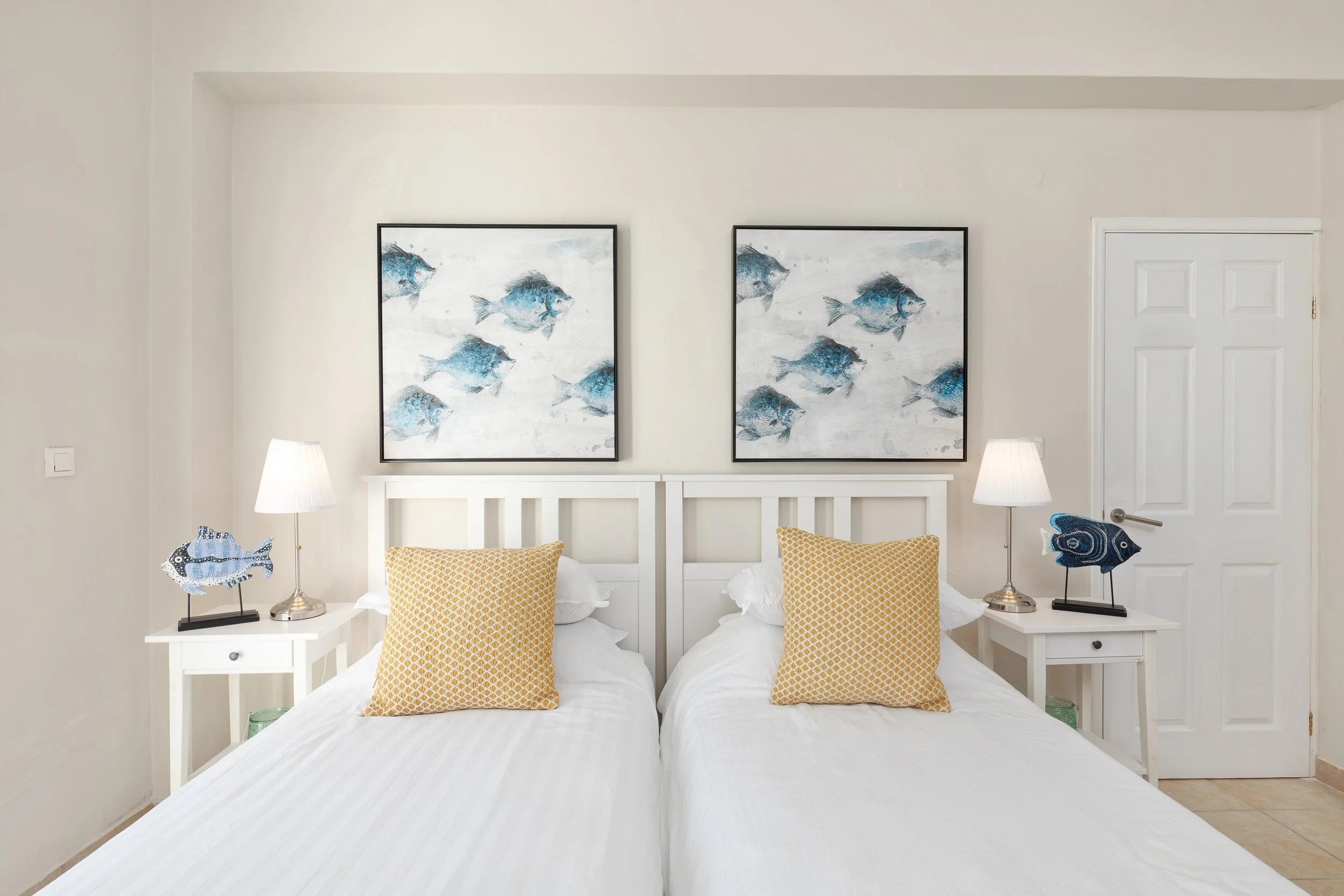 Upstairs double bedroom 1 at Villa Icarus Corfu with artwork over twin beds.