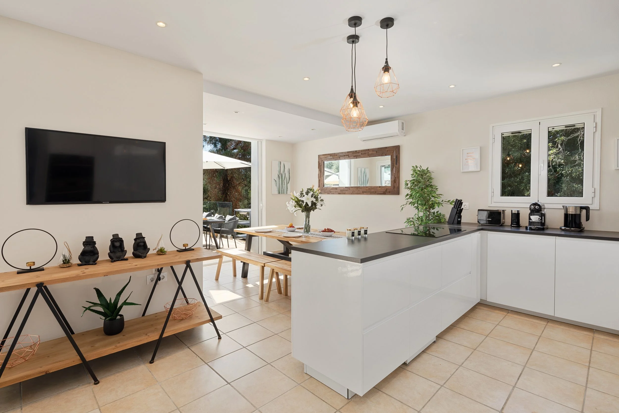 A view of the dining area and kitchen at Villa Icarus Corfu