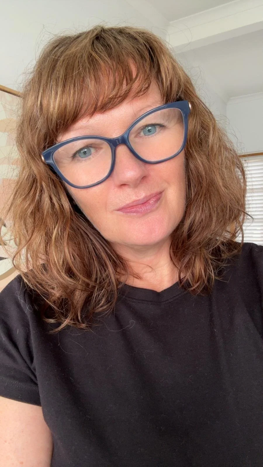 shelley wood looking to camera wearing glasses