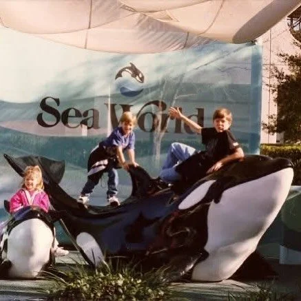 The Peters Family climbing an orca. Led by Matt. Don&rsquo;t worry. The blowhole is free and clear and no animal statues were harmed during the taking of this photo.