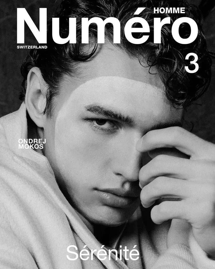 Black and white cover of Número Homme magazine featuring a close-up portrait of a young man with curly hair, intense gaze, and hand partially covering one eye. The cover includes the text 'Número Homme 3, Switzerland, Ondrej Moks, Sérénité'.