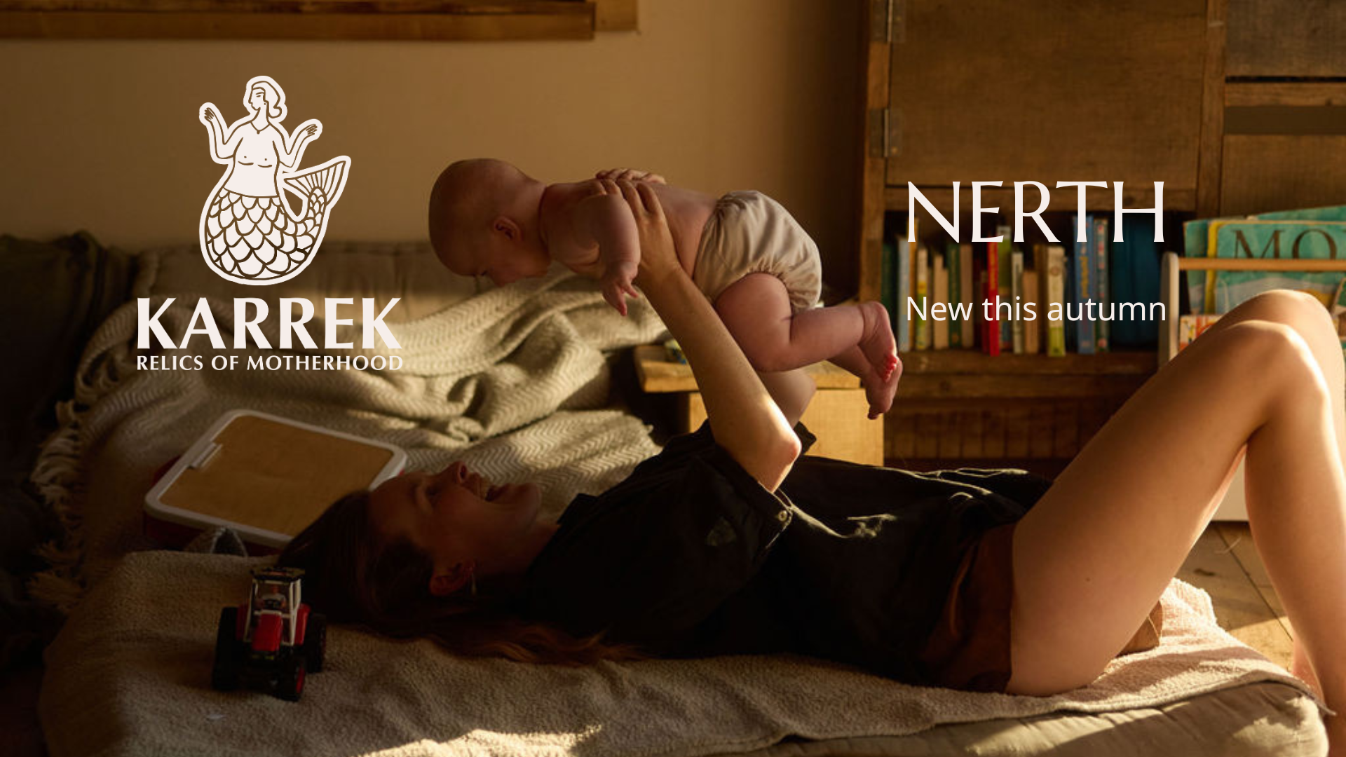 A woman lying on a bed, holding a baby above her with both hands, in a cozy wooden room with a bookshelf in the background, and the Karrek logo and text overlay.