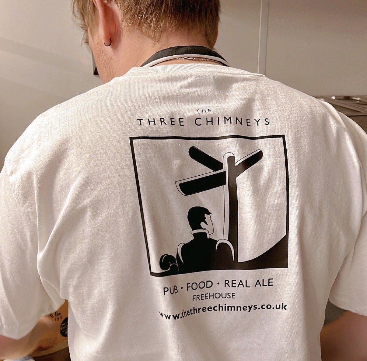 Chef preparing fresh dishes in The Three Chimneys kitchen wearing branded team uniform.