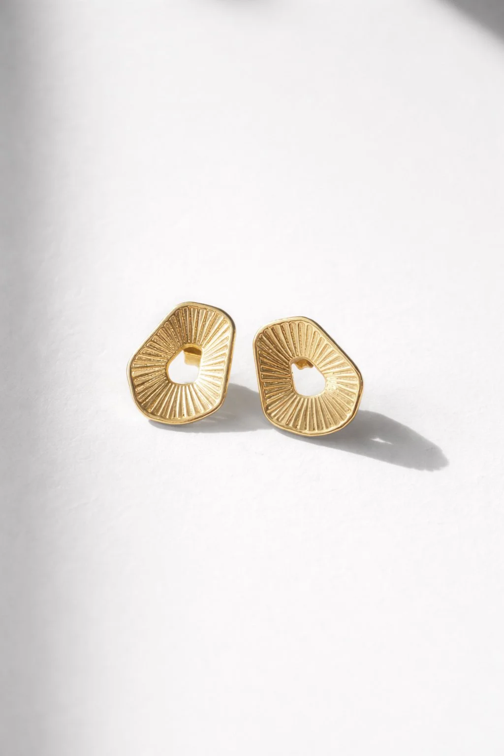 Golden sunburst stud earrings close-up.jpg