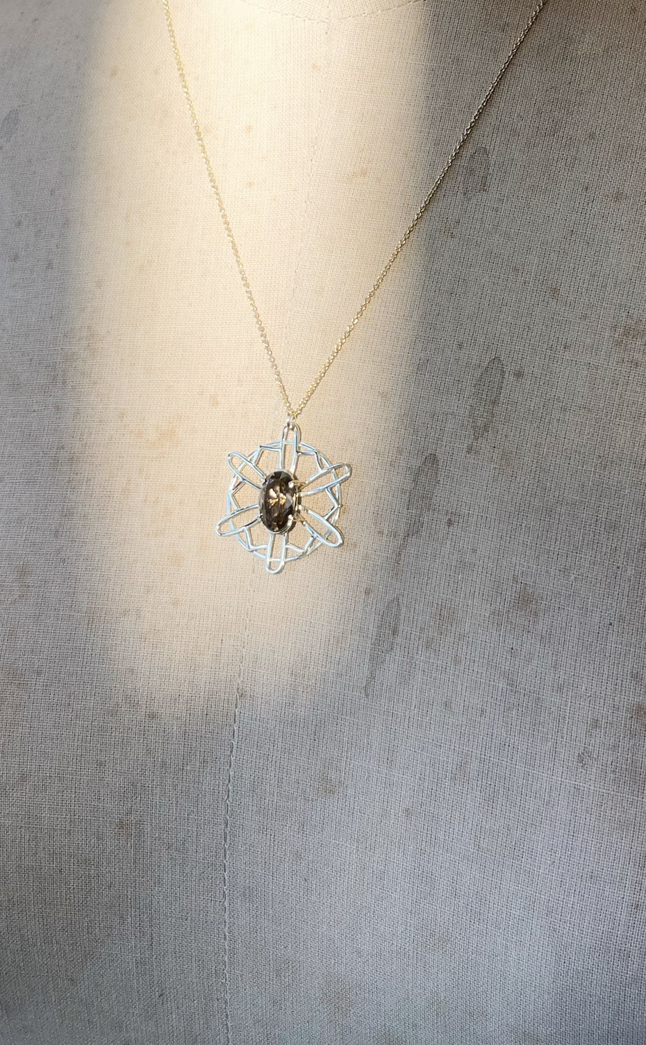 Gold necklace with geometric pendant