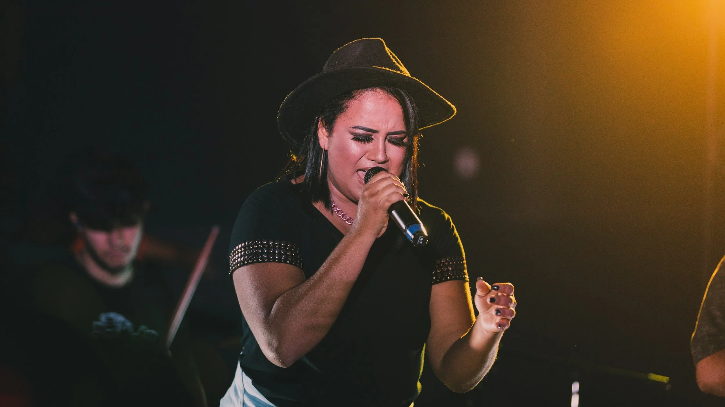 Live music performance on stage, singer with backing musician