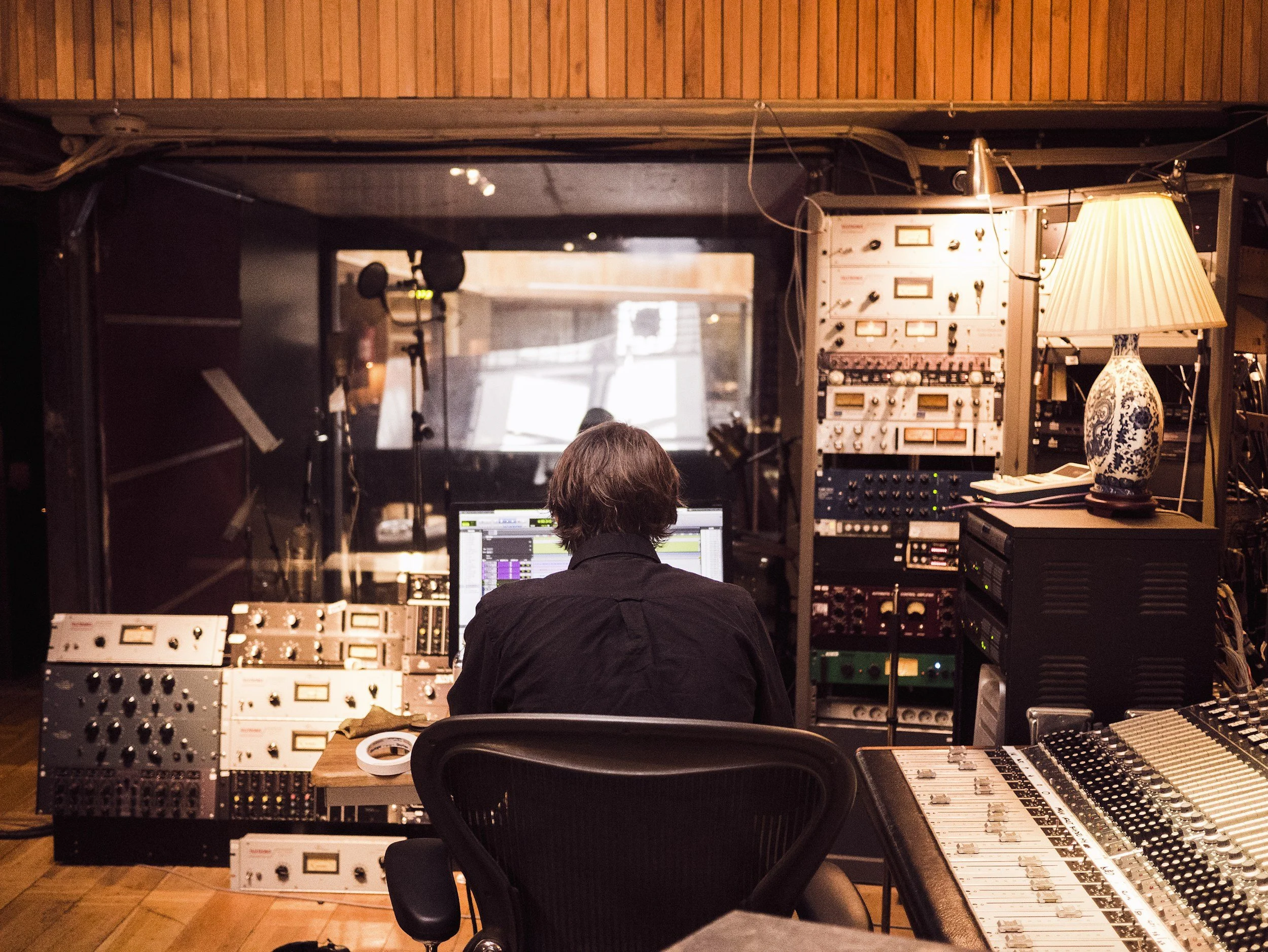 Recording studio control room with mixing console and audio equipment