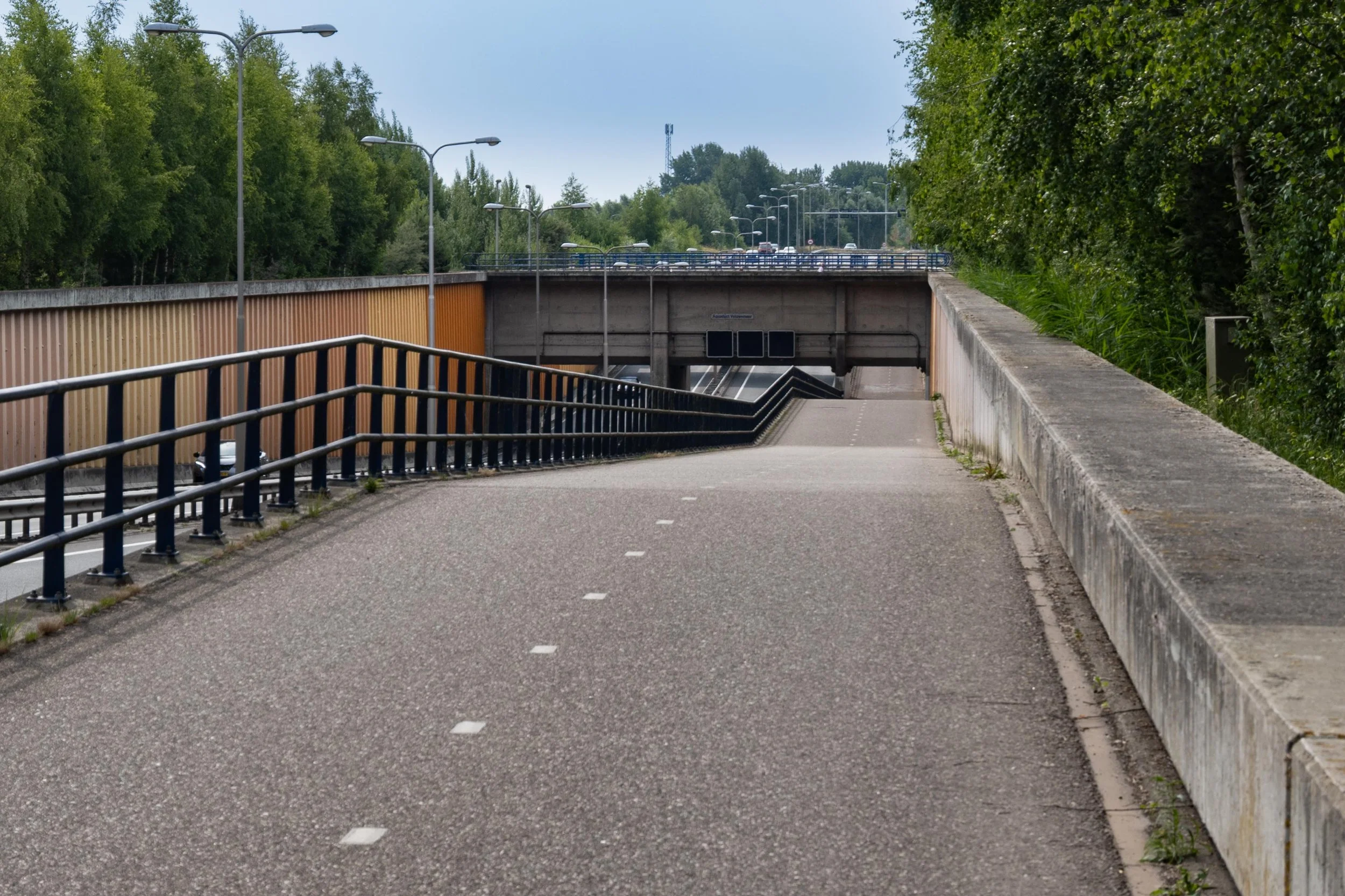 Bike path under aqueduct (water bridge for boats), Netherlands