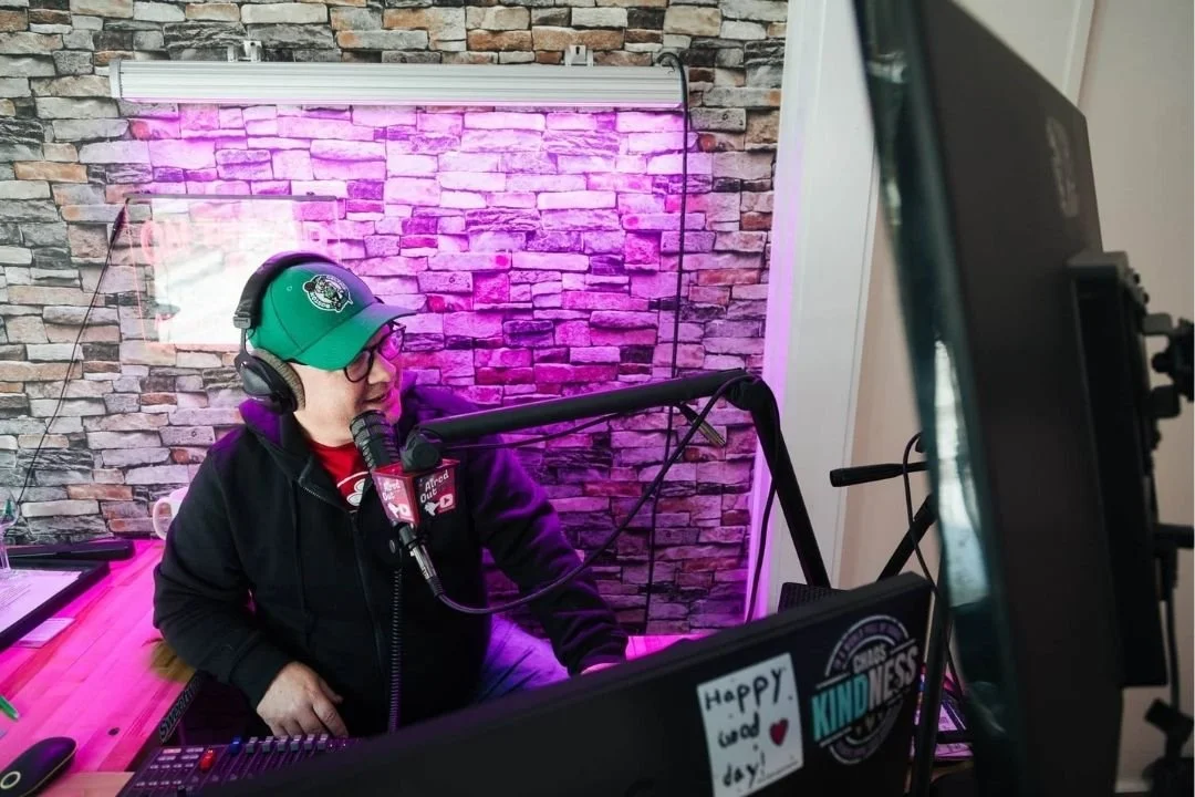 JD Greene from Aired Out behind a microphone recording his podcast