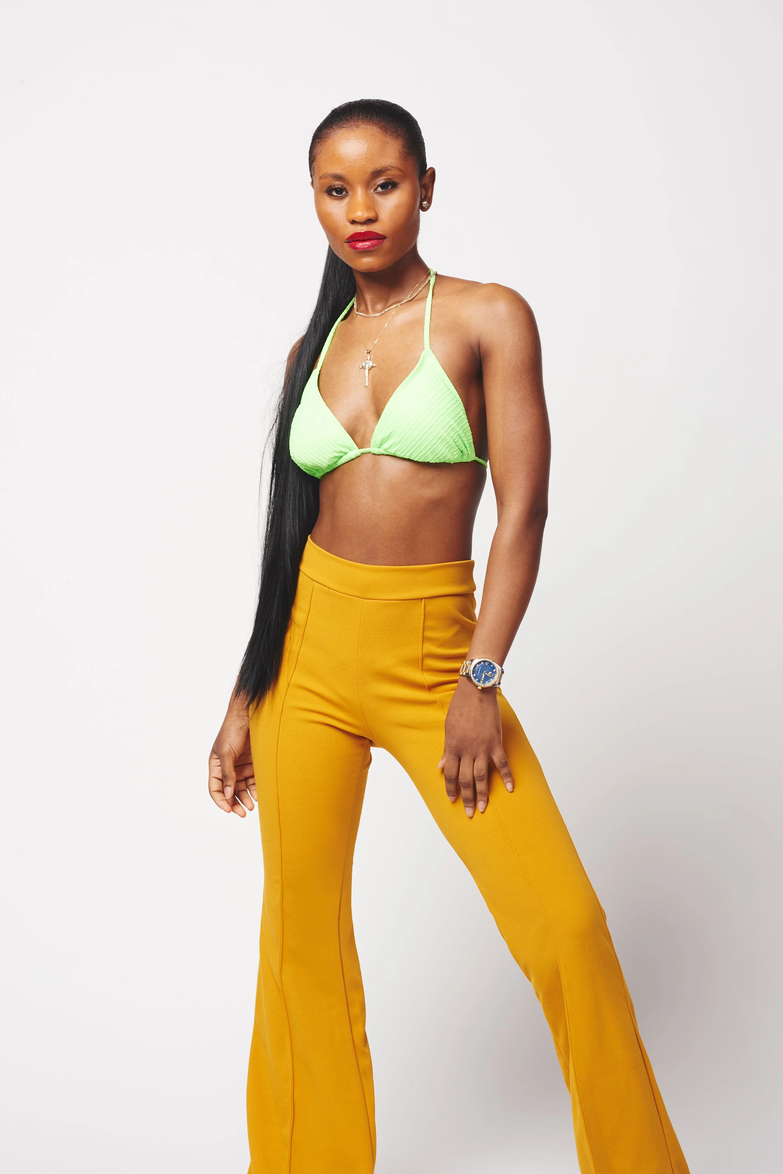 burlington vermont fashion photo shoot image of woman in green swimsuit top and yellow pants