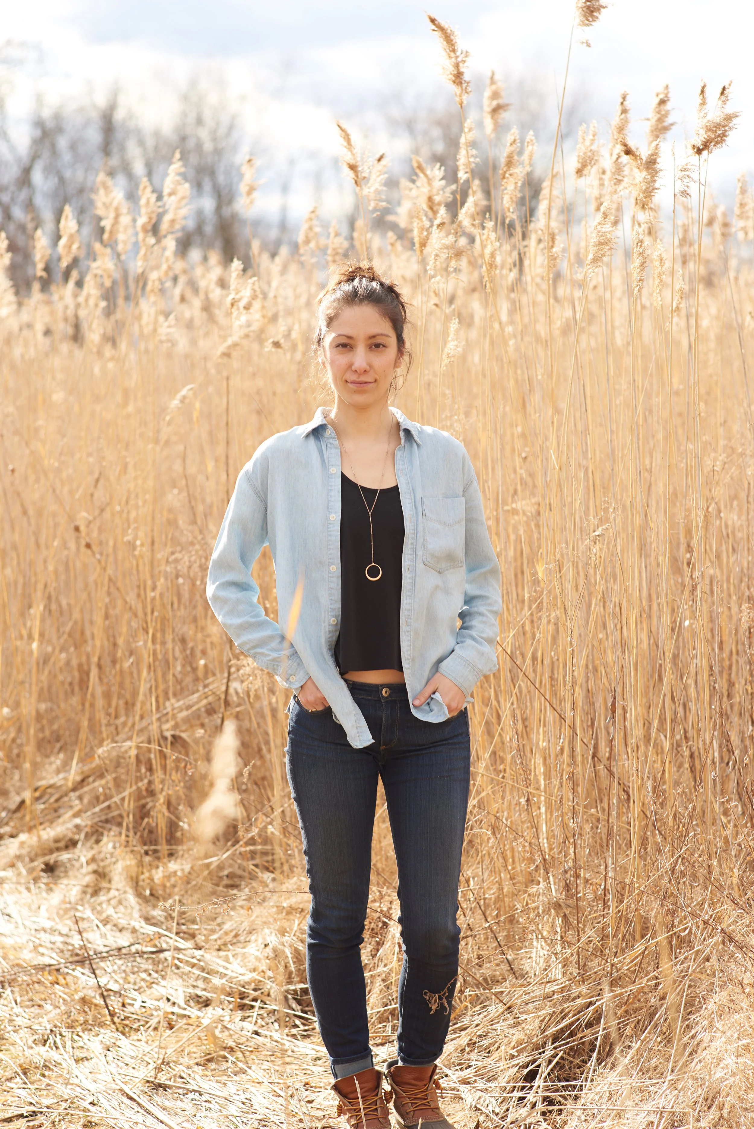 portrait of rhiannon kim in front of field or reeds in vermont during early fall