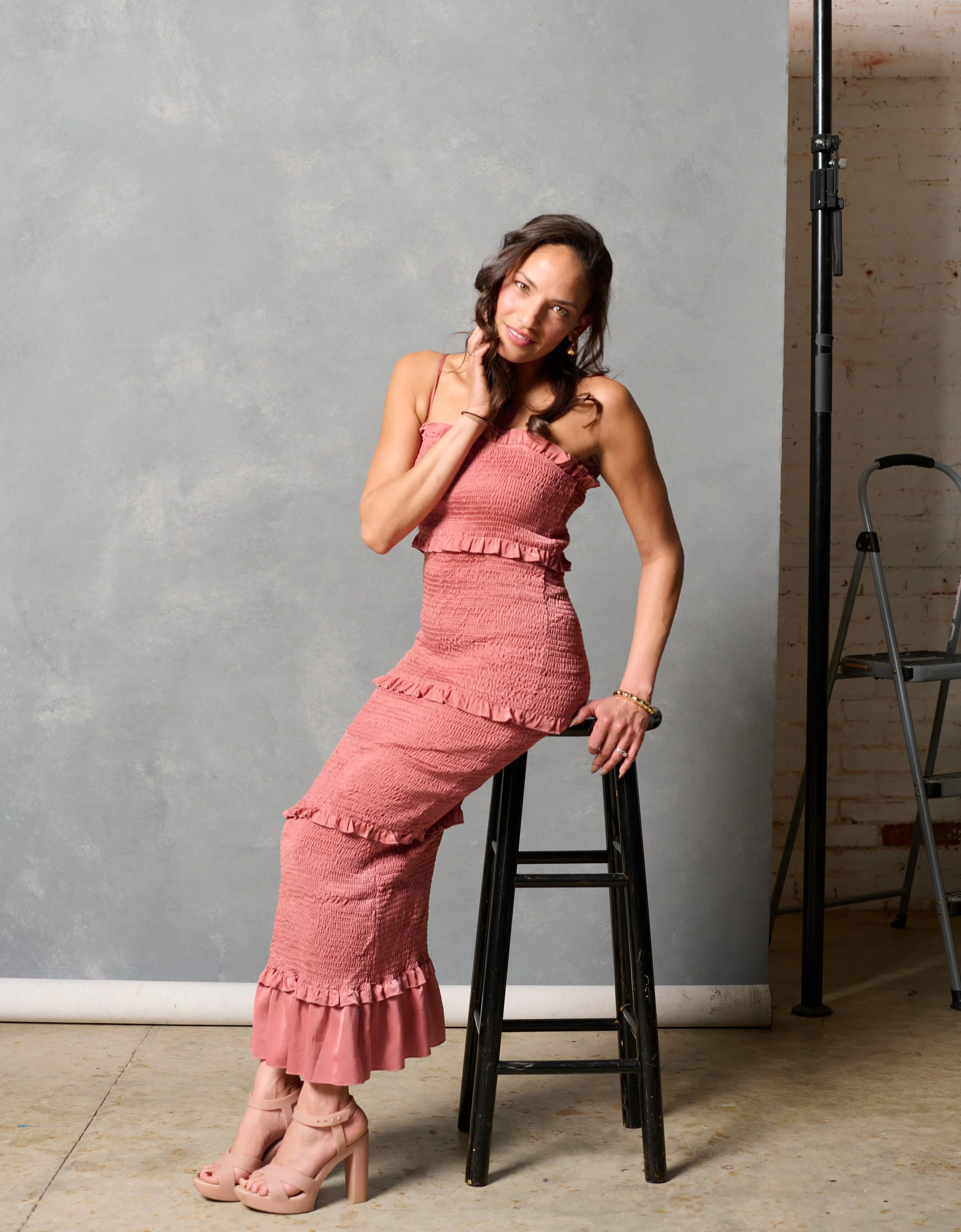 beautiful woman sitting on a black stool during a Burlington vermont studio fashion shoot