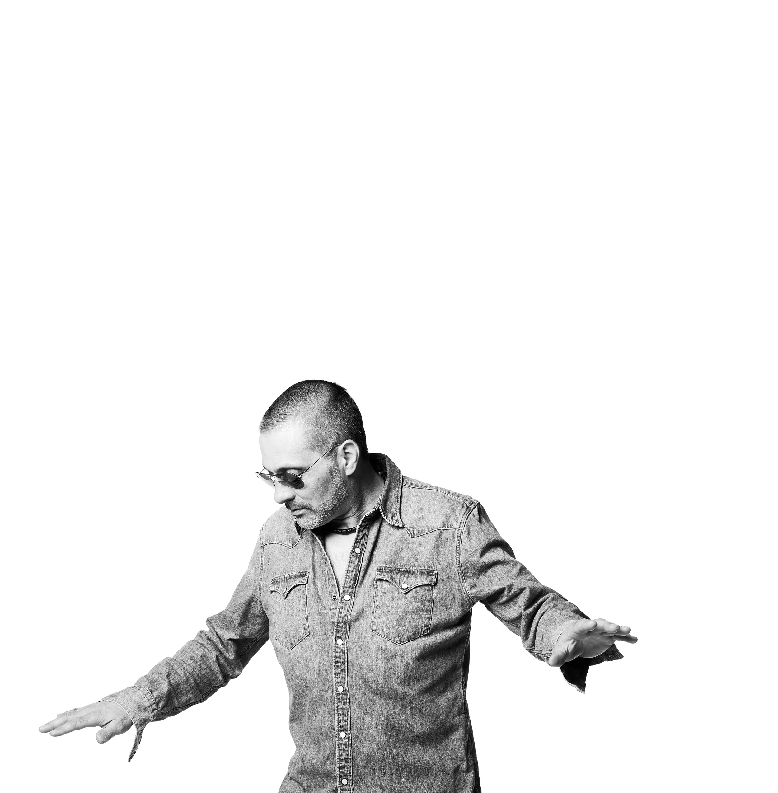 black and white portrait of a man wearing sunglasses with his arms held out to his sides