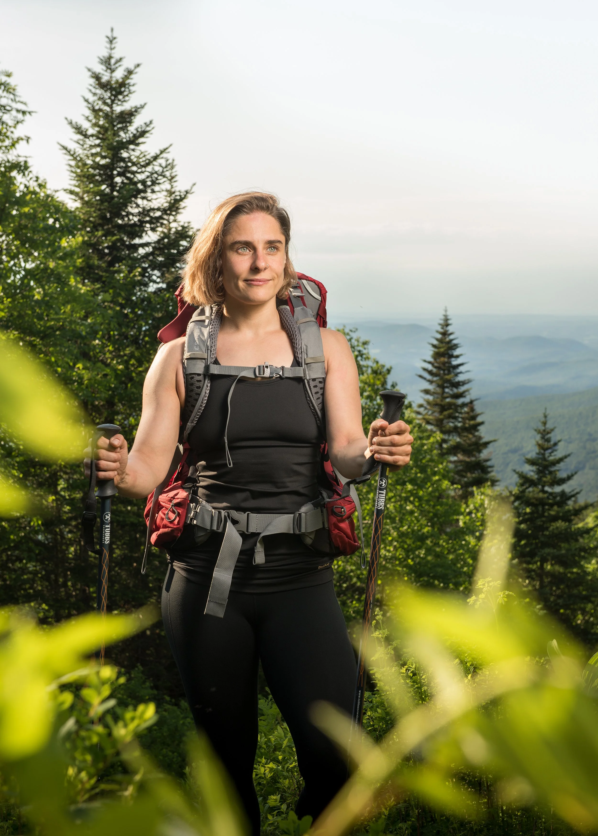 portrait of betsy leblanc on mt mansfield with her backpack and trekking poles