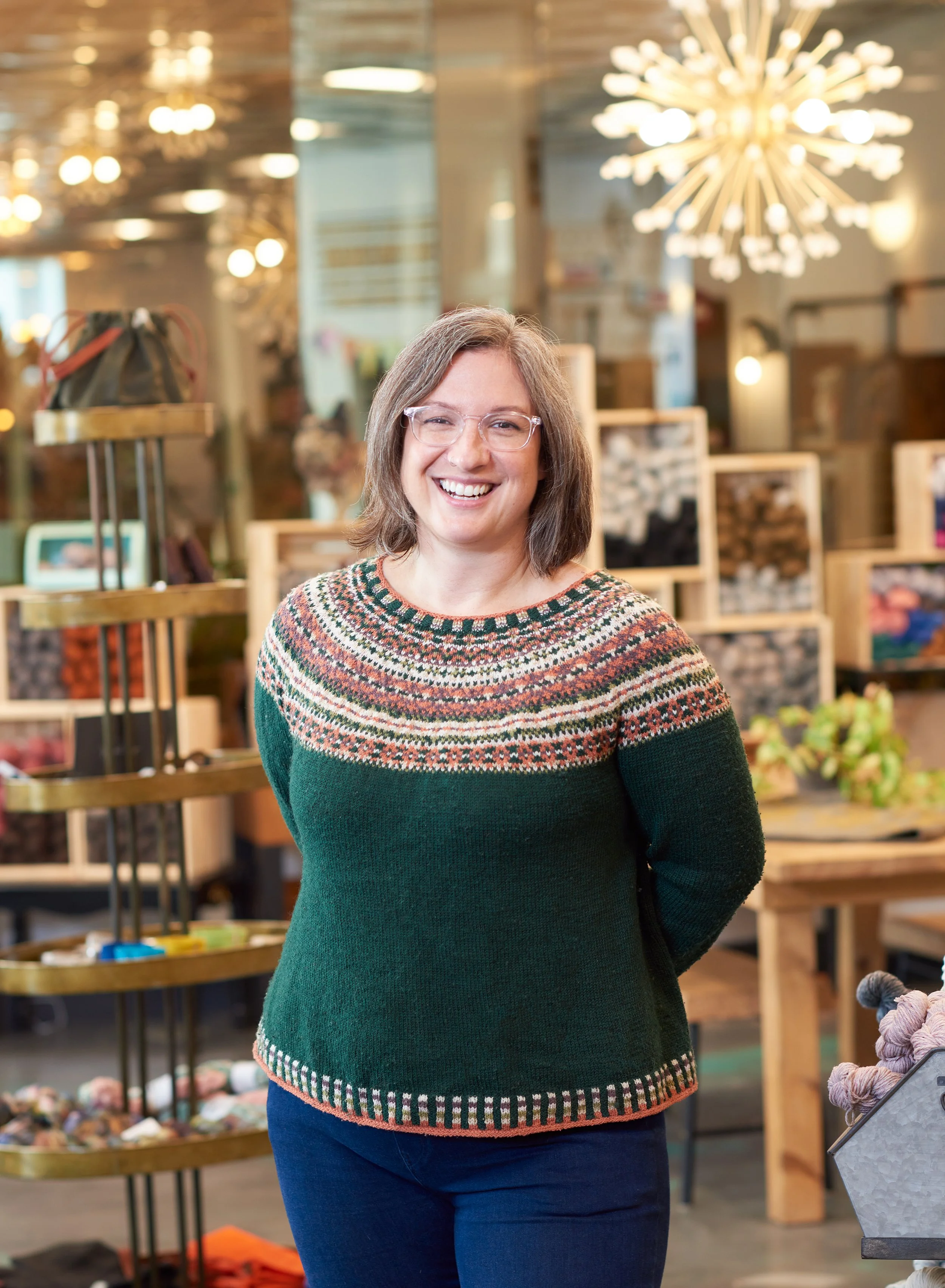 female business owner poses for camera in her store in new hampshire