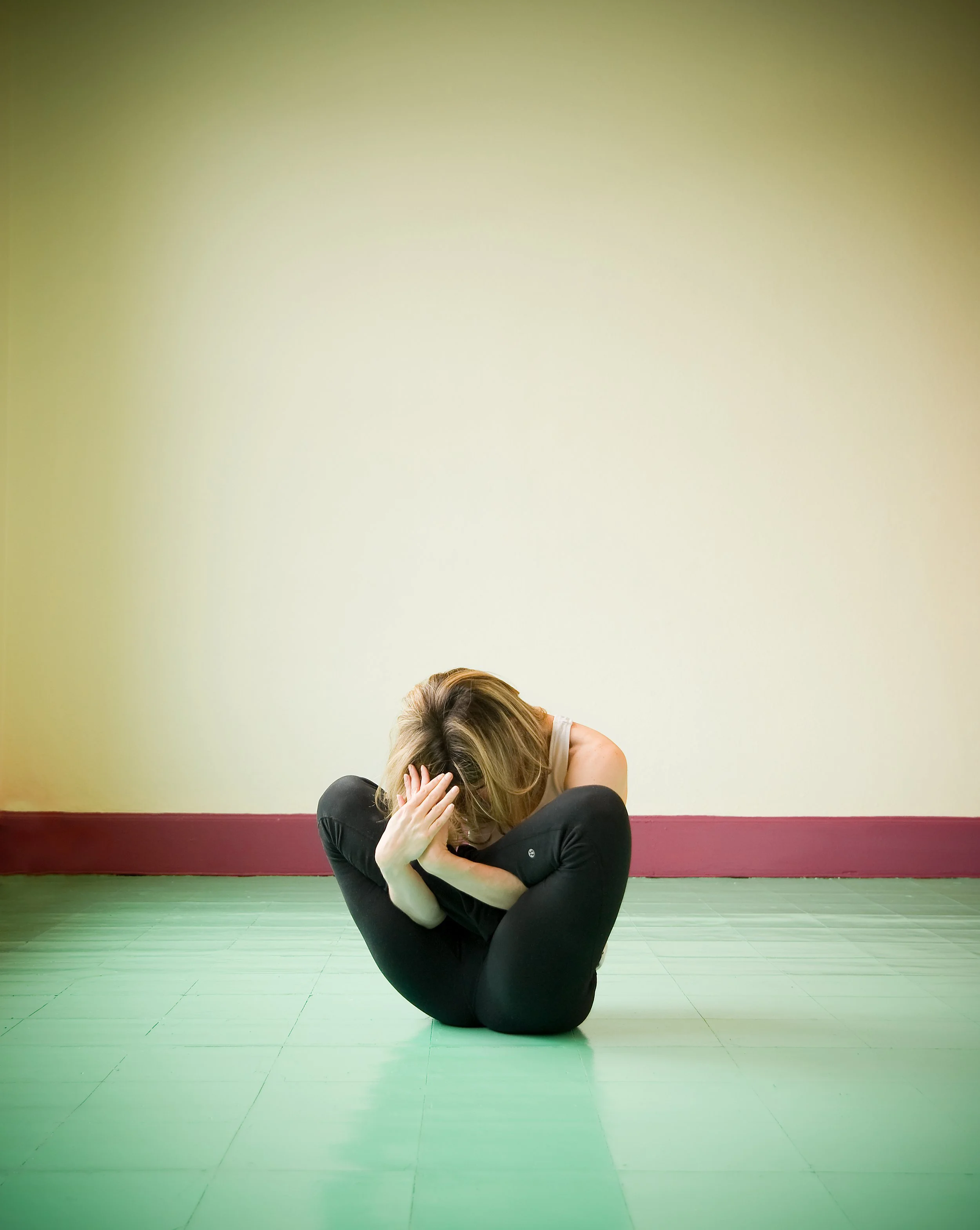 woman in yoga pose on green floor