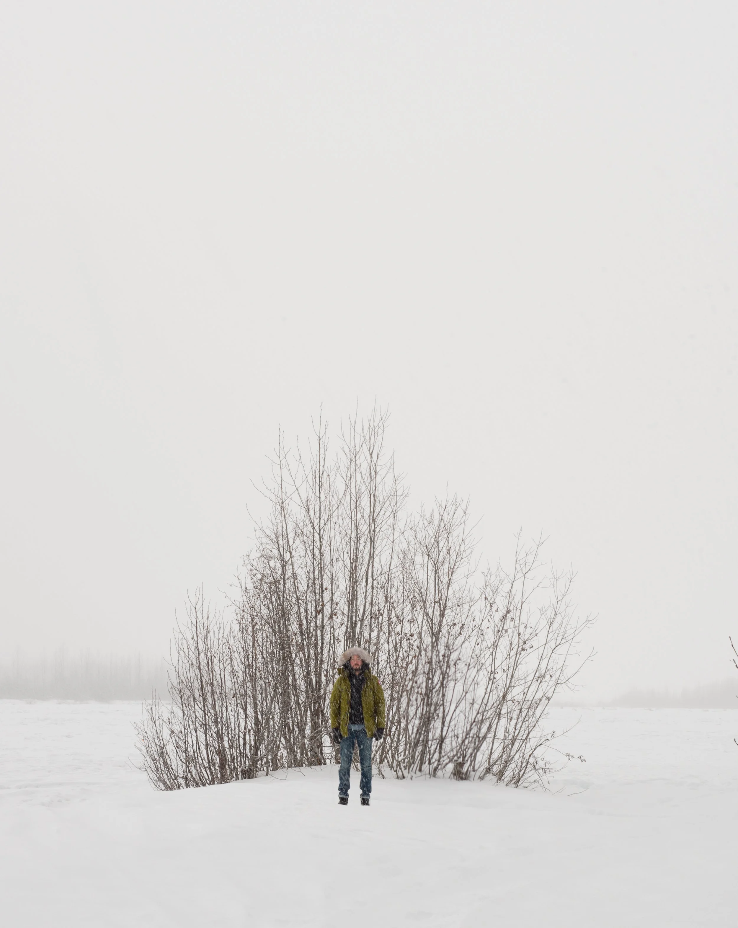 michael heeney self portrait in front of small group of trees in alaska