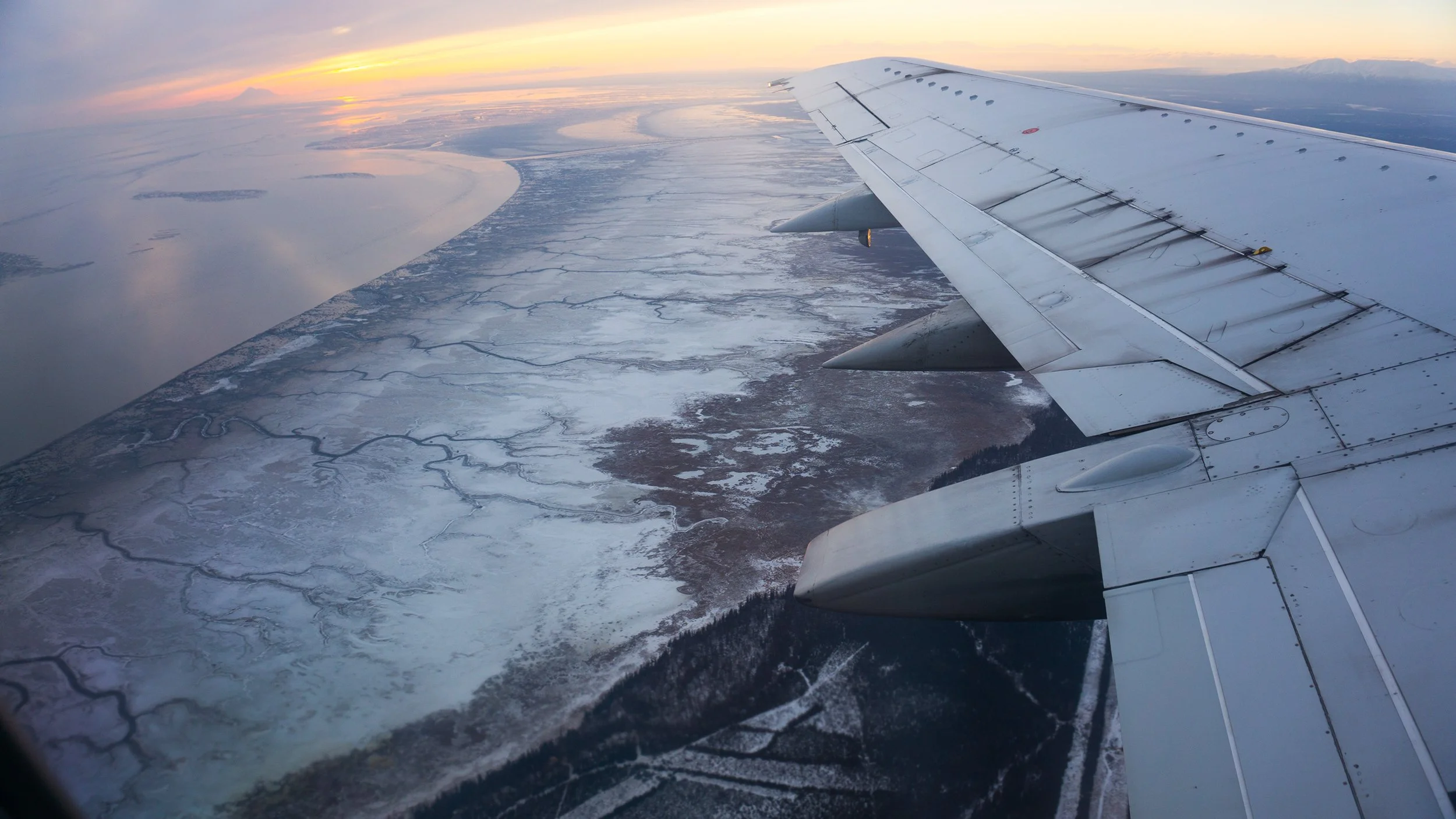 aerial view of alaskan coast with plane wing travel photography