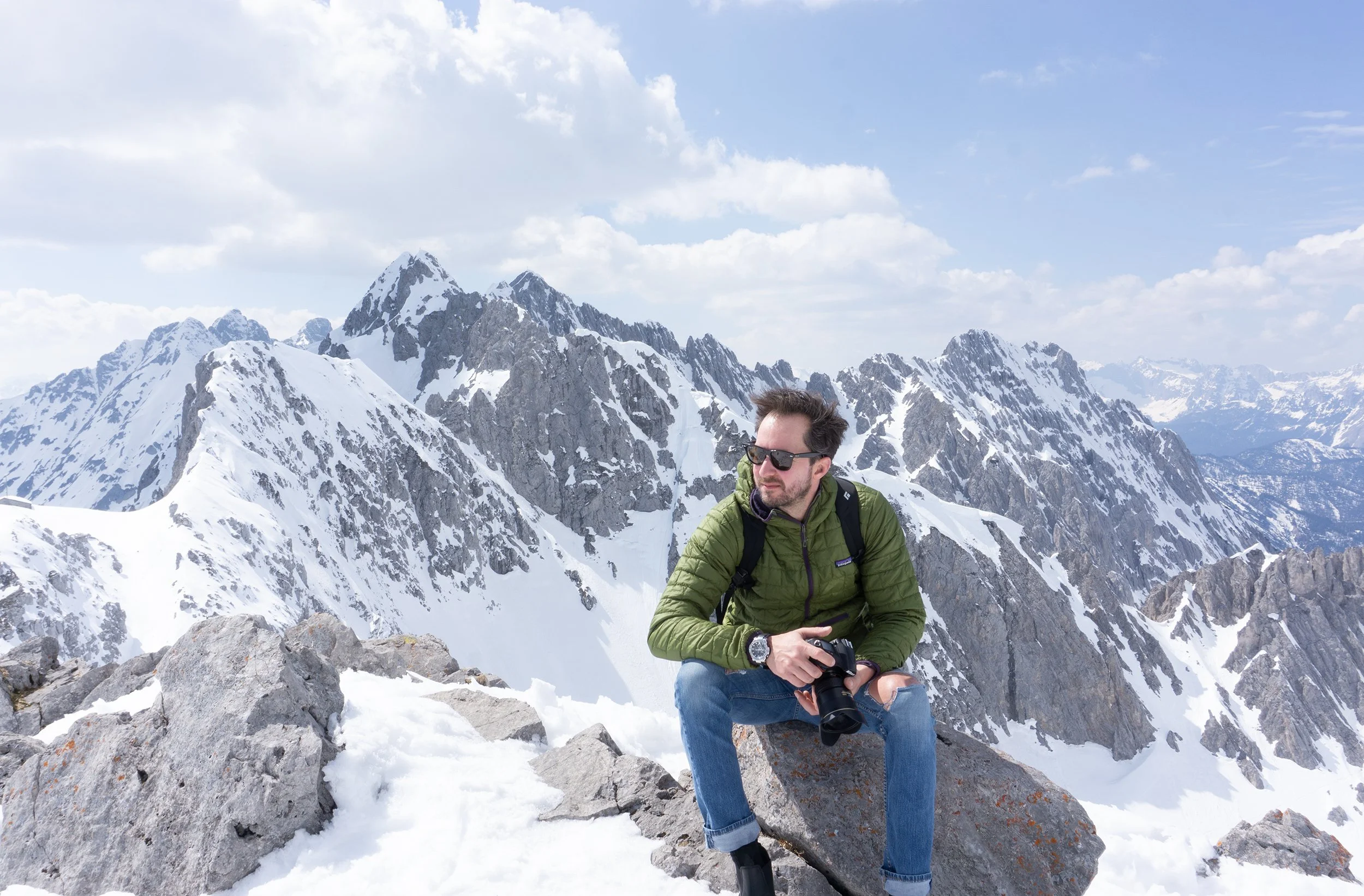 michael heeney on  mountain top in austria with camera in hand