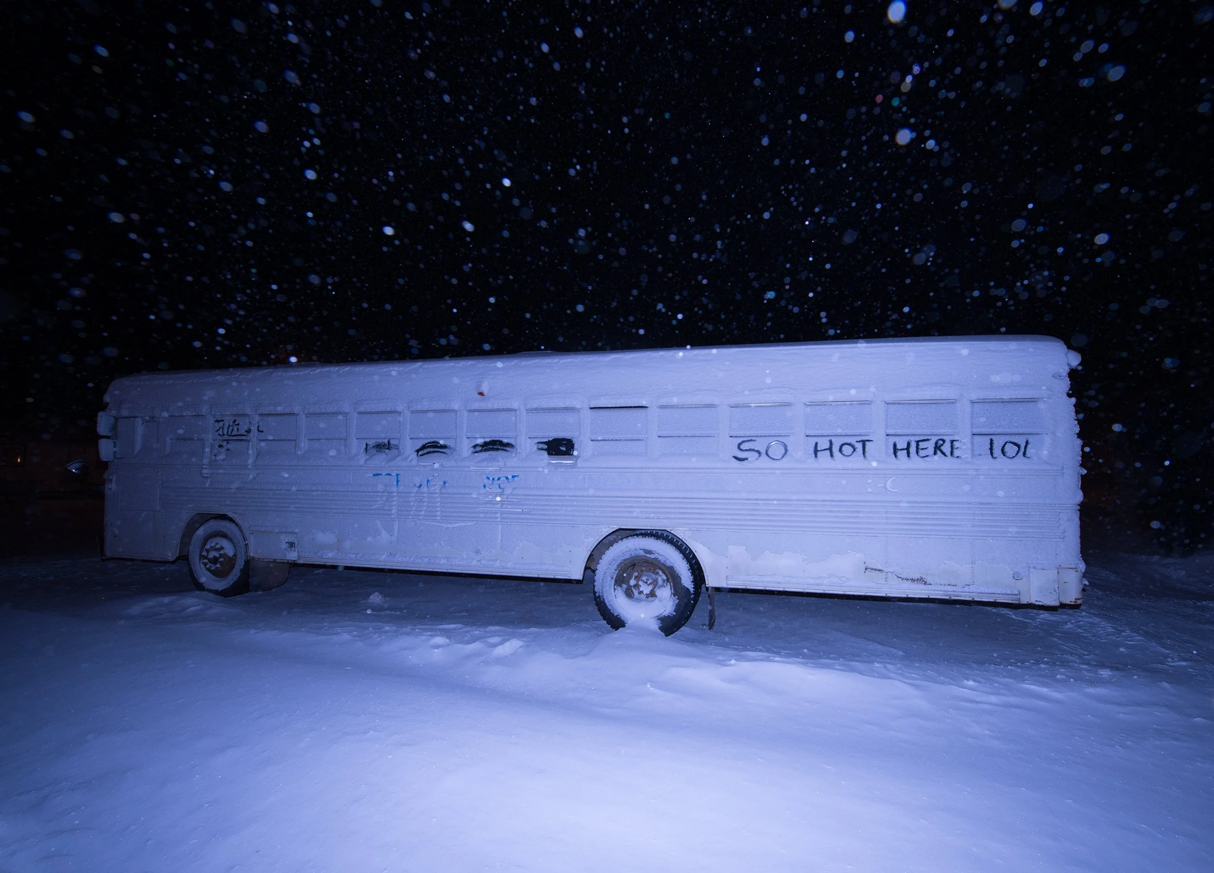 snow covered bus at night in alaska
