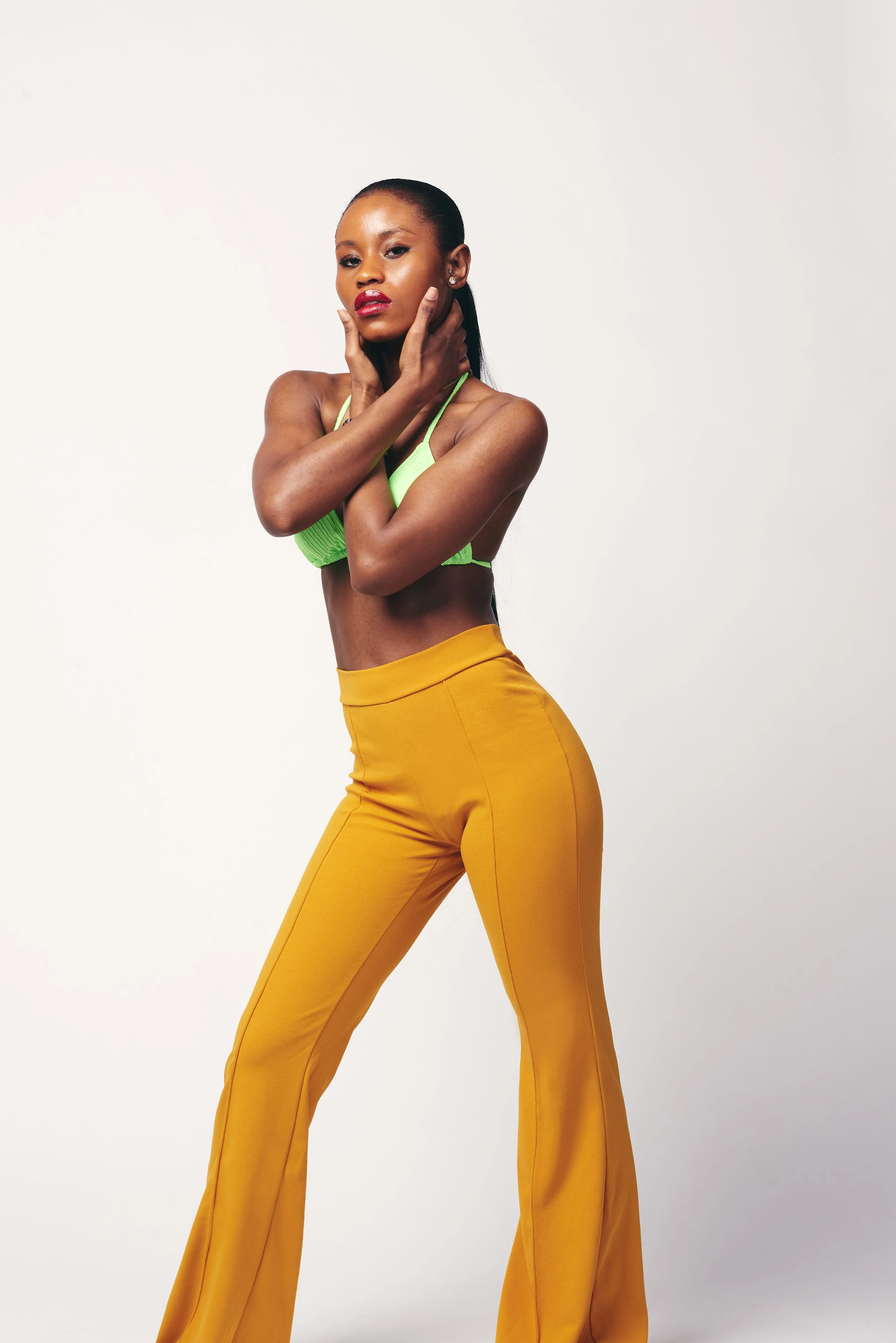 woman in green swimsuit top and yellow pants taken during fashion photo shoot in Burlington vt