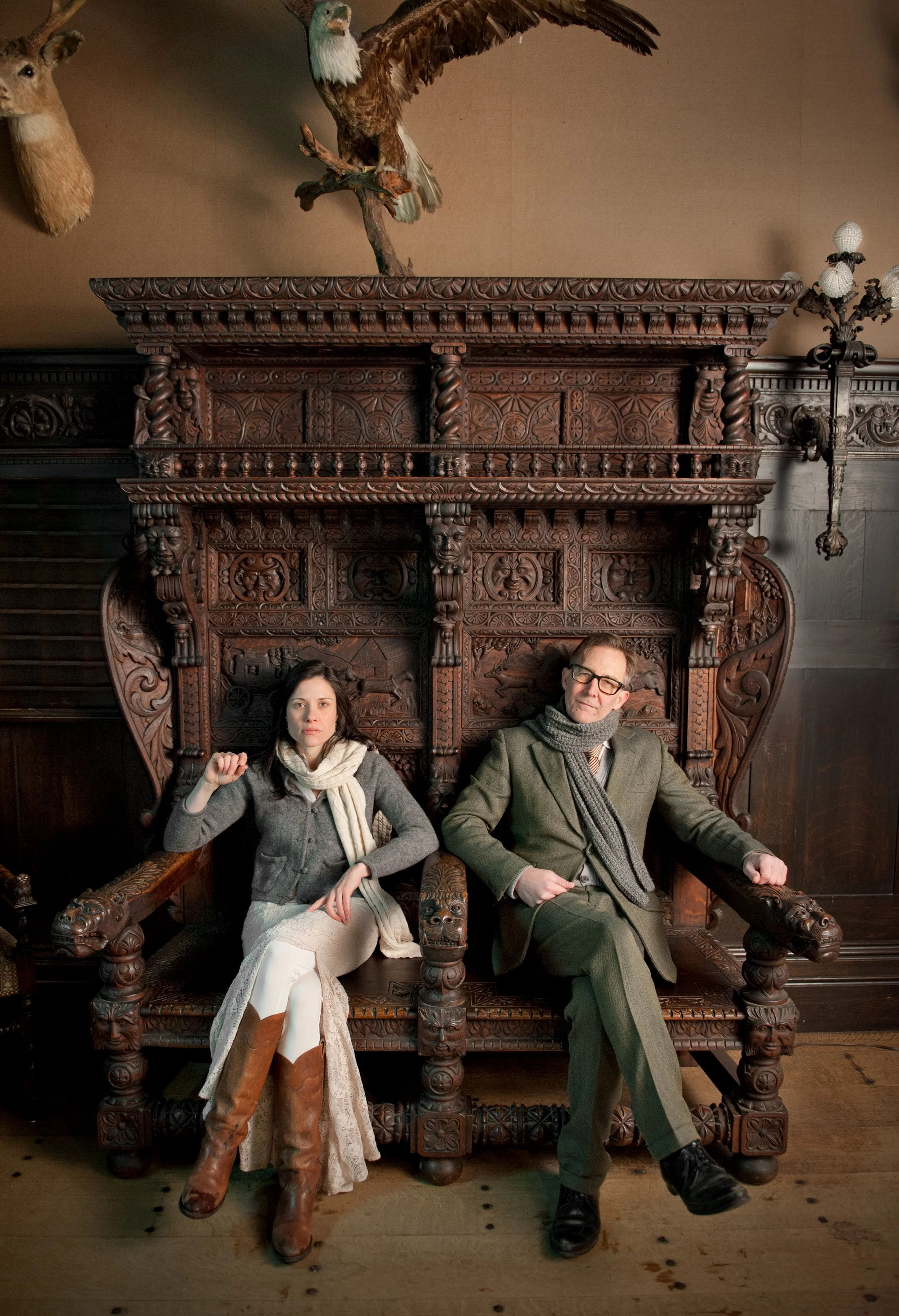 musicians brett hughes and shannon mcnally sit on hand carved chairs at shelburne farms in vermont