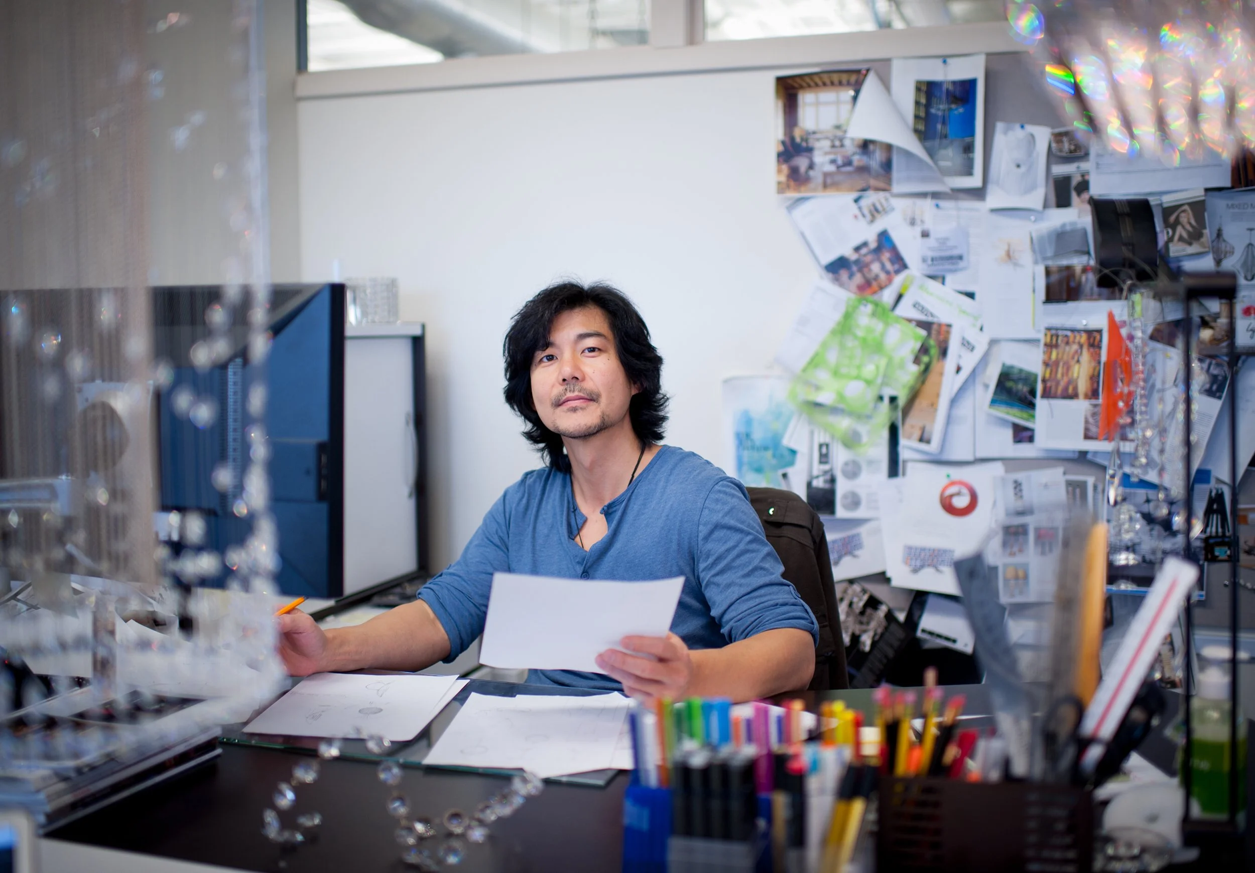 editorial portrait of a swarovski lighting designer seated at his desk