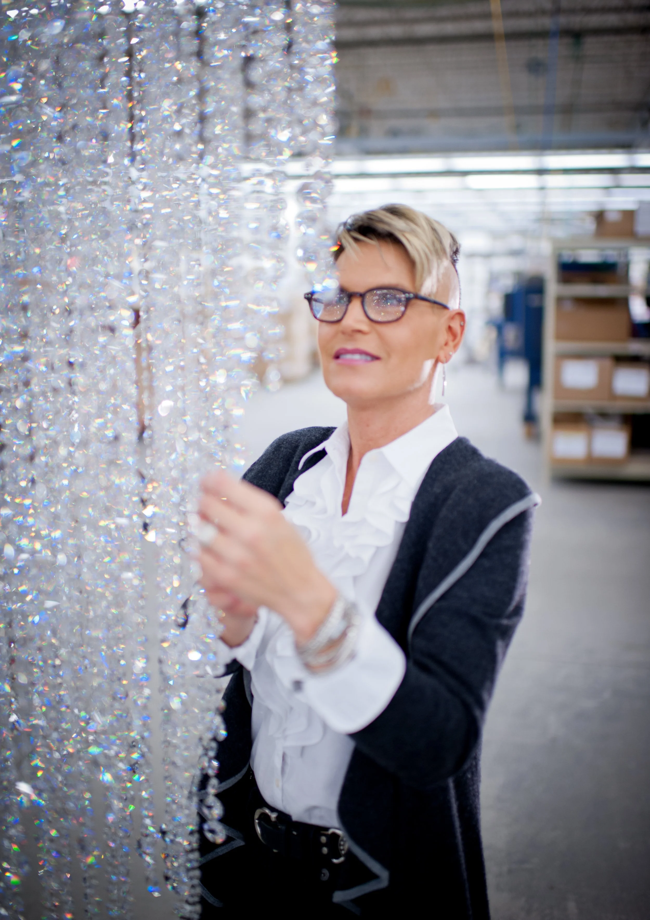swarovski lighting designer inspects a crystal chandelier on the factory floor in plattsburgh ny