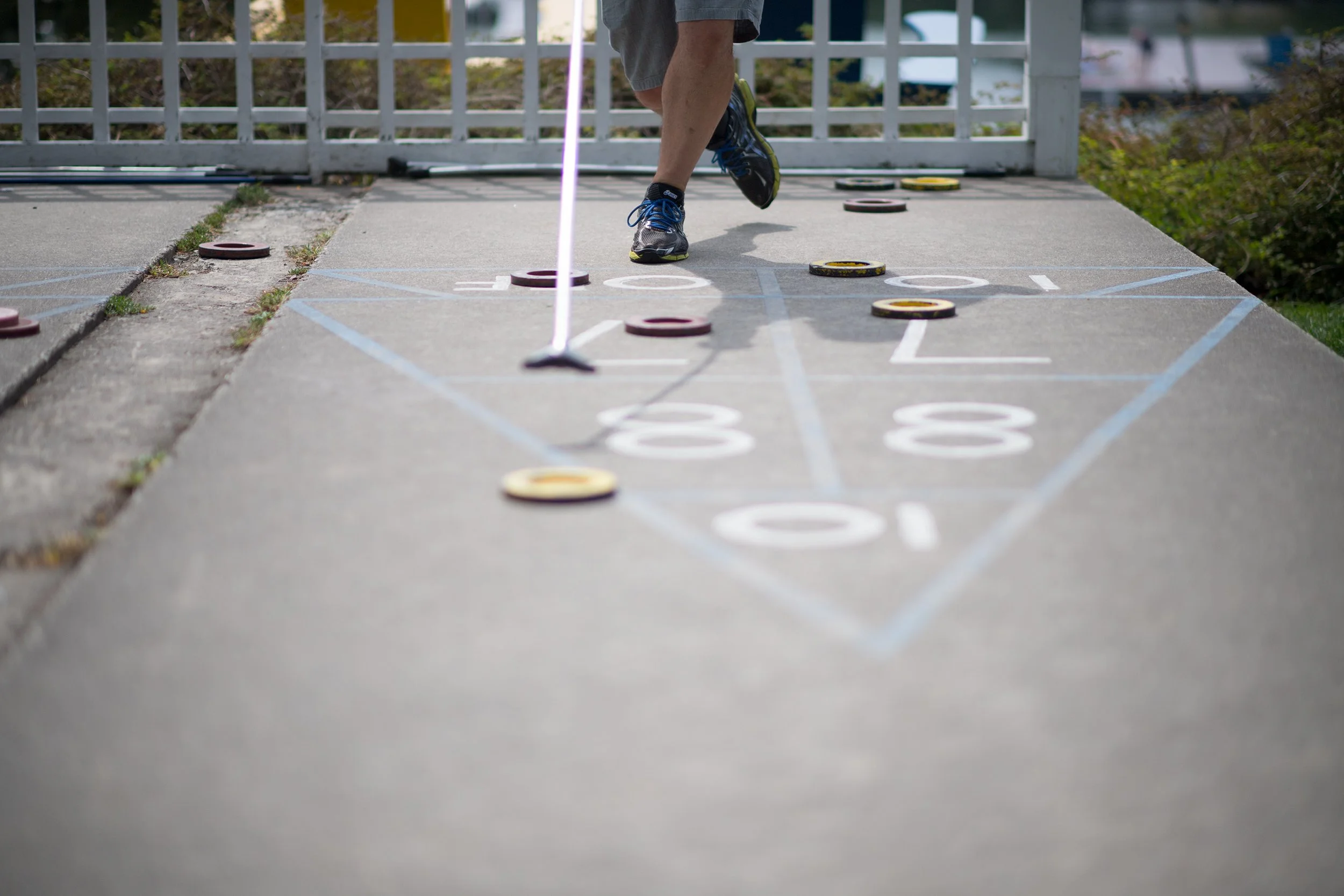 a man playing shuffleboard