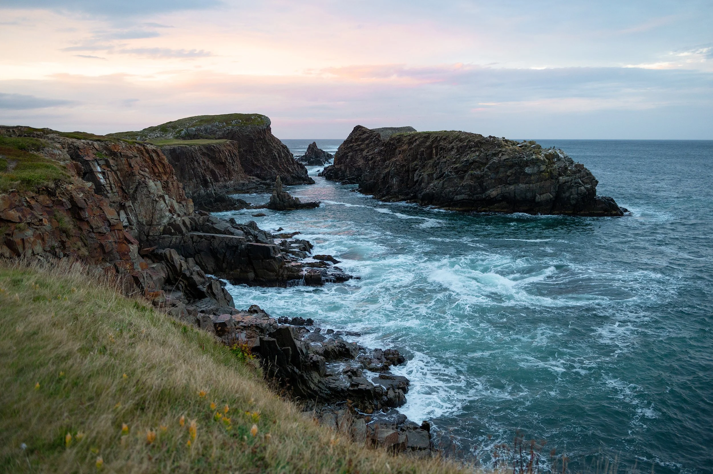 dramatic coastline of newfoundland at sunset