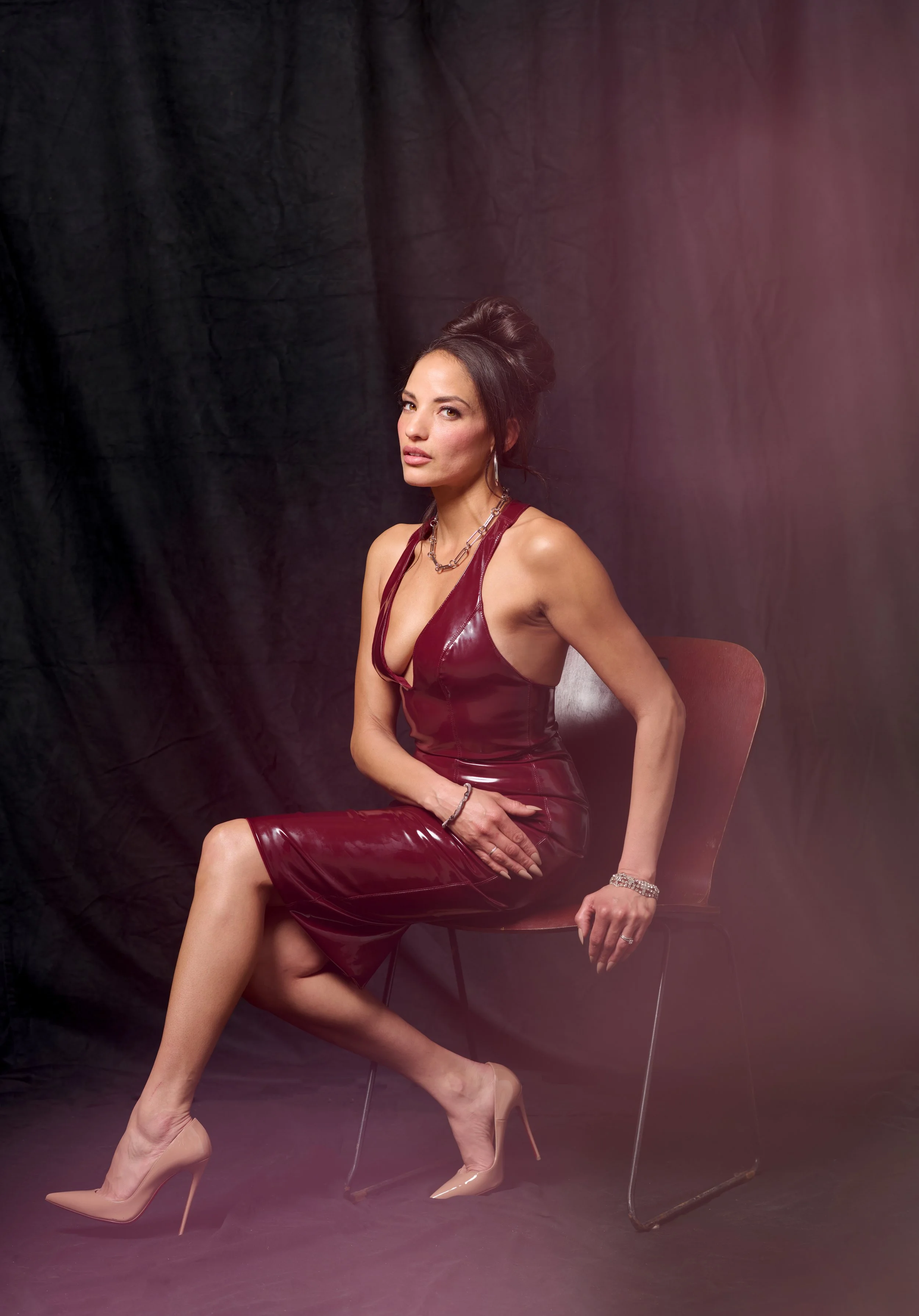 fashion photo shoot with woman in red dress sitting on a chair in Burlington vermont photography studio
