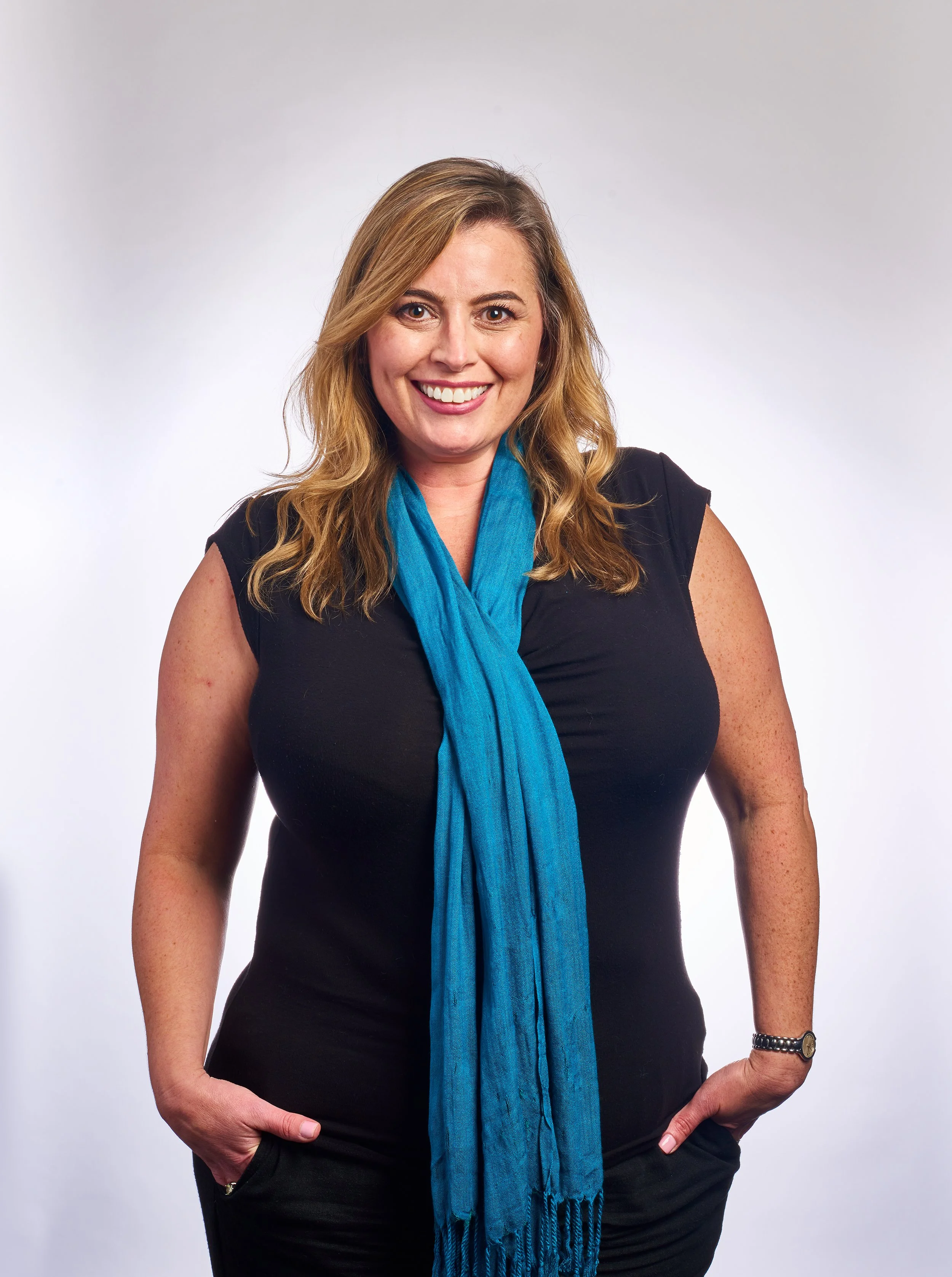 headshot of a smiling vermont employee wearing a blue scarf taken in Burlington vermont photography studio