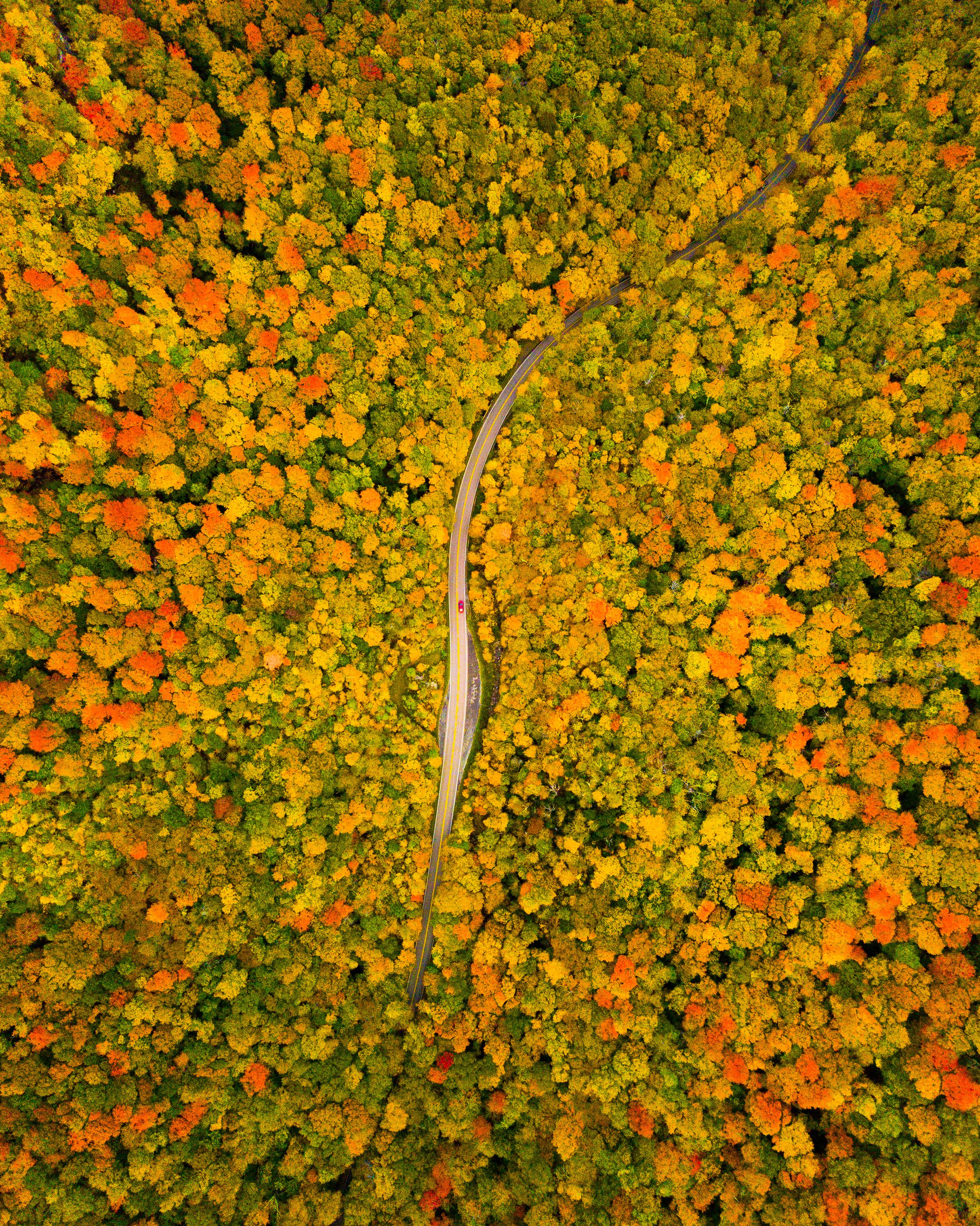 drone aerial photography of route 108 through smugglers notch in vermont during fall season
